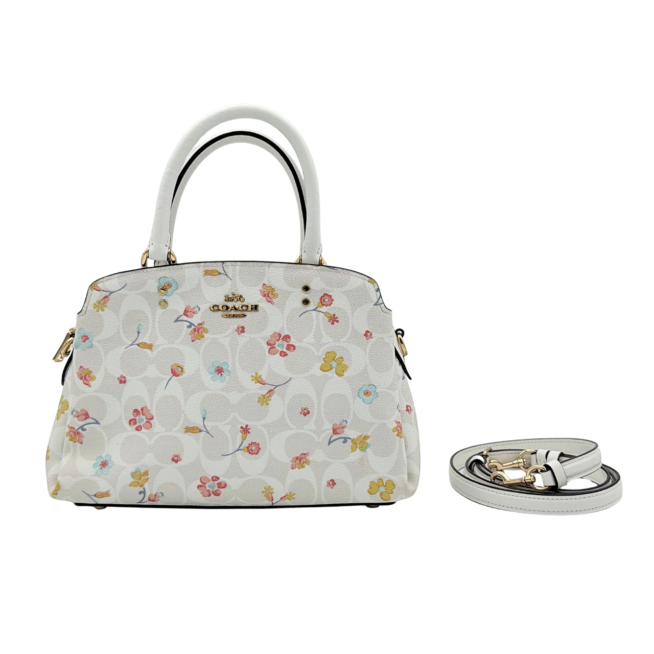 Coach 2Way Signature Lillie Carryall in white canvas with gold hardware and multicolour floral print, accompanied by a detachable white shoulder strap.