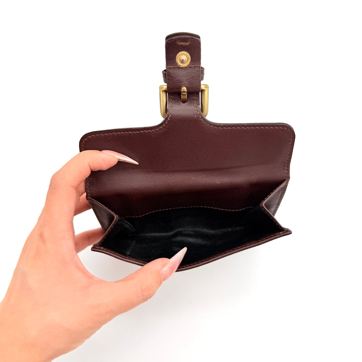 Burberry Nova Check wallet in beige and brown with leather trim and brass buckle detail photographed on white background.