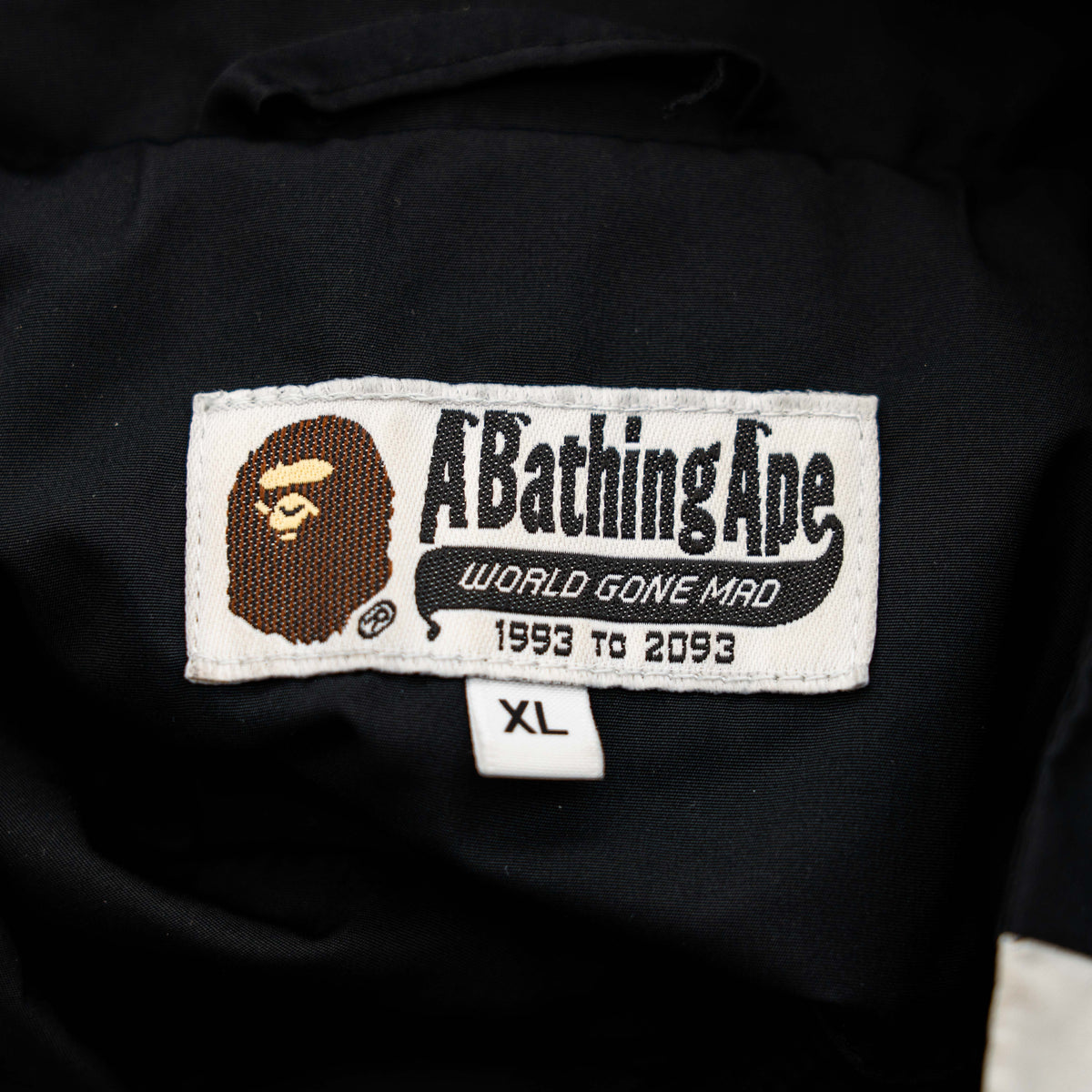 BAPE A Bathing Ape black and white logo track jacket with bold panel detailing, shown laid flat.