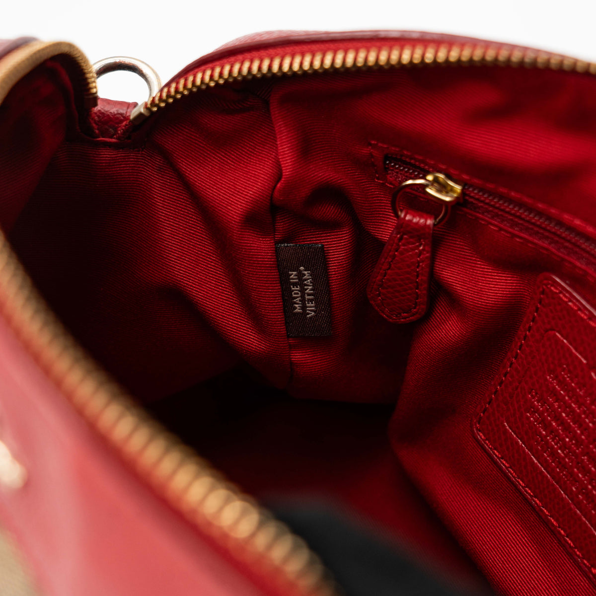 Coach Mini Bennett Boston bag in signature beige canvas with red leather trim, shown with detachable crossbody strap.