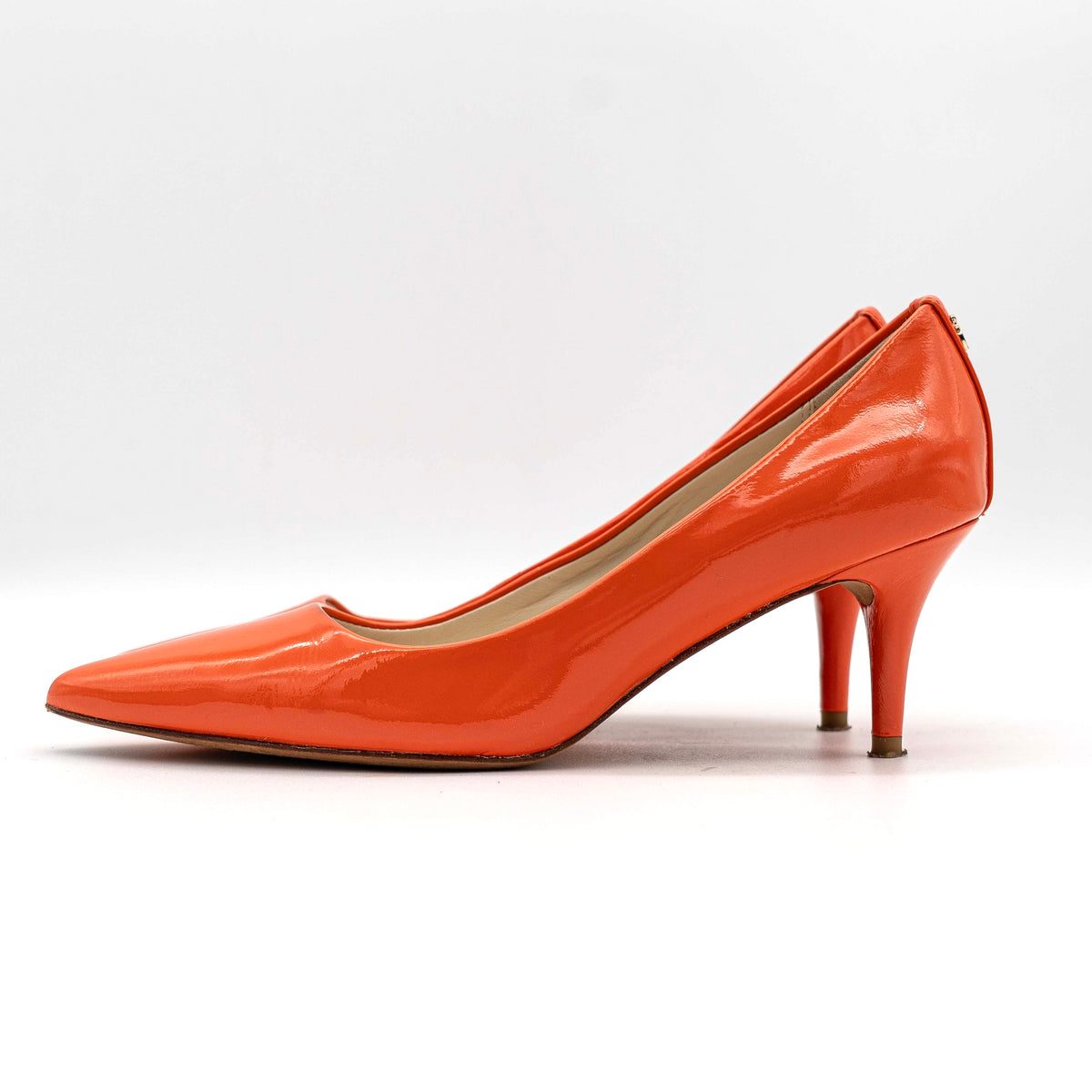 Pair of Coach orange patent leather pointed-toe heels with gold logo detail, size EU 35.5.