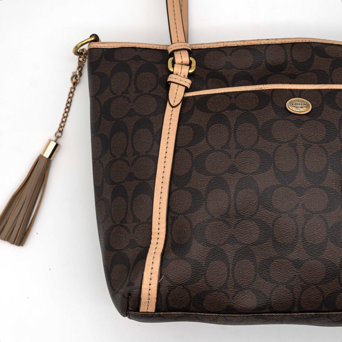 Coach Signature Peyton Pocket tote bag in brown canvas with tan leather trim, shown with both handles and detachable strap.