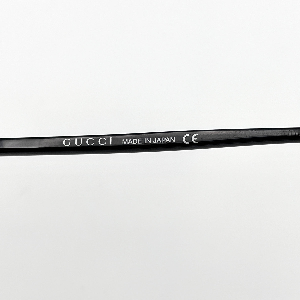 Gucci GG0064SK 001 black round sunglasses with smoky lenses, shown with original burgundy velvet case and pouch.