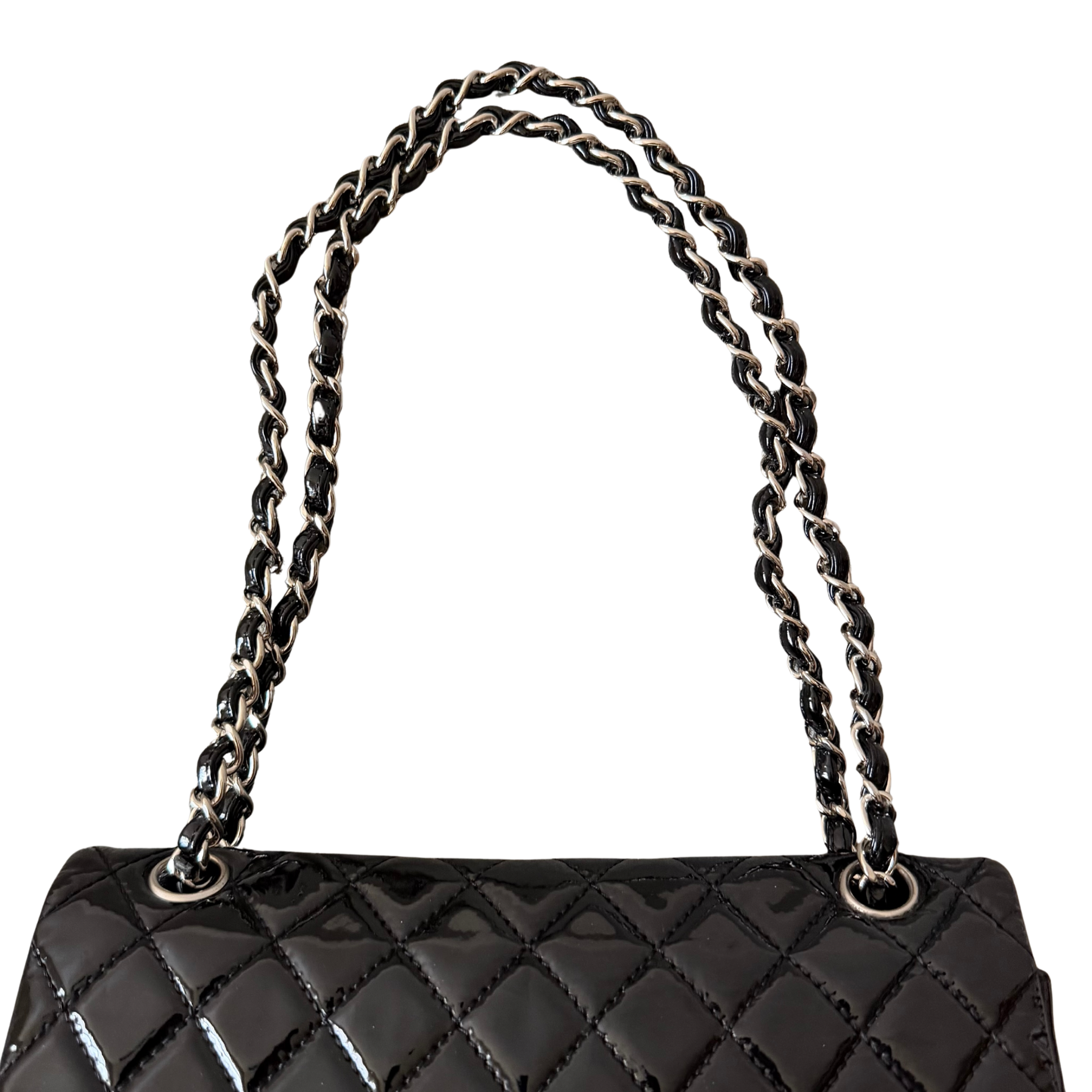 Chanel 25 Matelasse Double Flap bag in glossy black patent leather with silver-tone hardware and quilted finish.