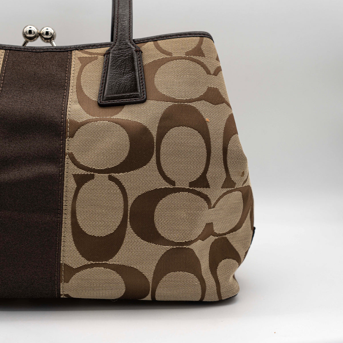 Coach Signature Stripe Frame Kisslock Shoulder Bag in beige and brown canvas with leather trim and signature monogram pattern.