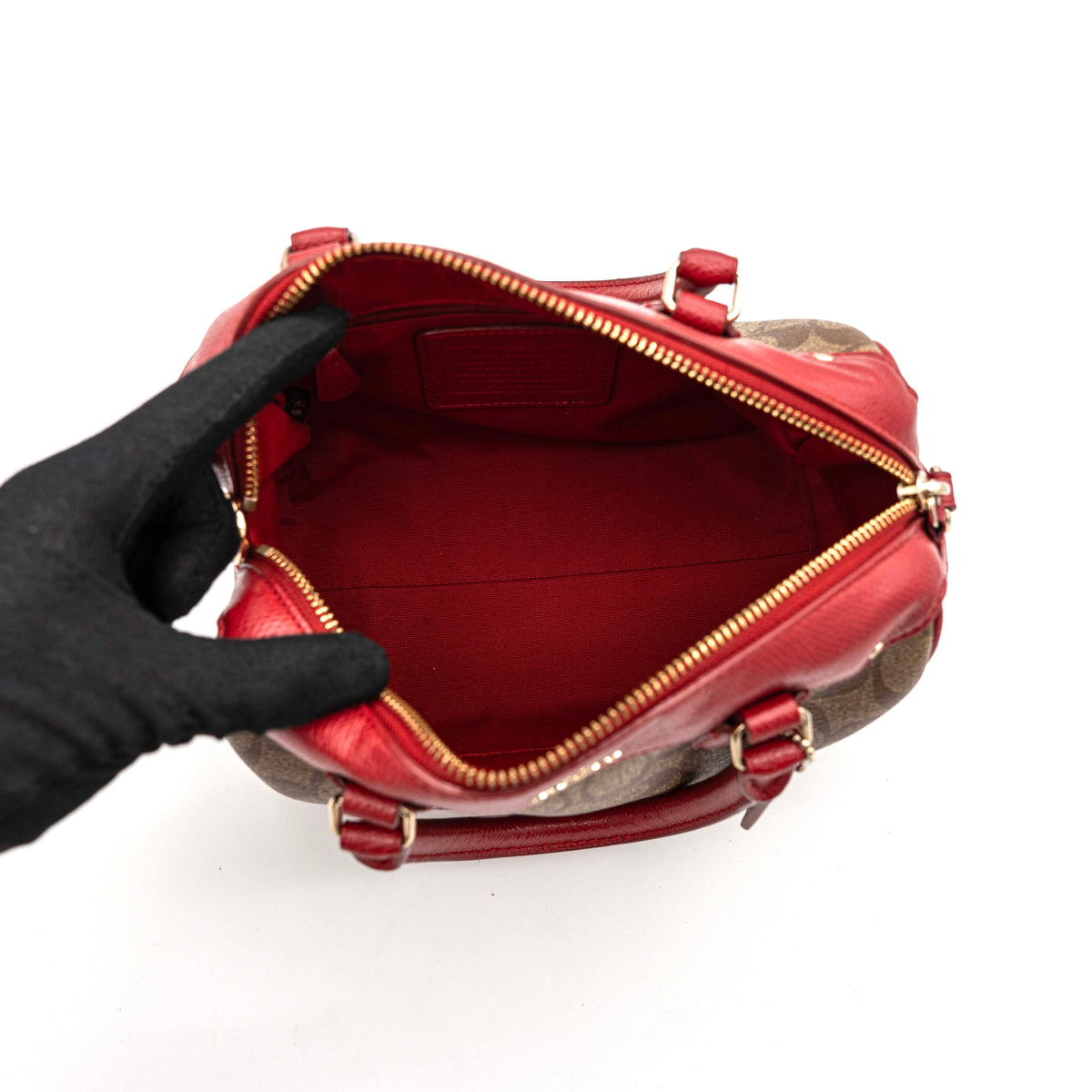 Coach Mini Bennett Boston bag in signature beige canvas with red leather trim, shown with detachable crossbody strap.