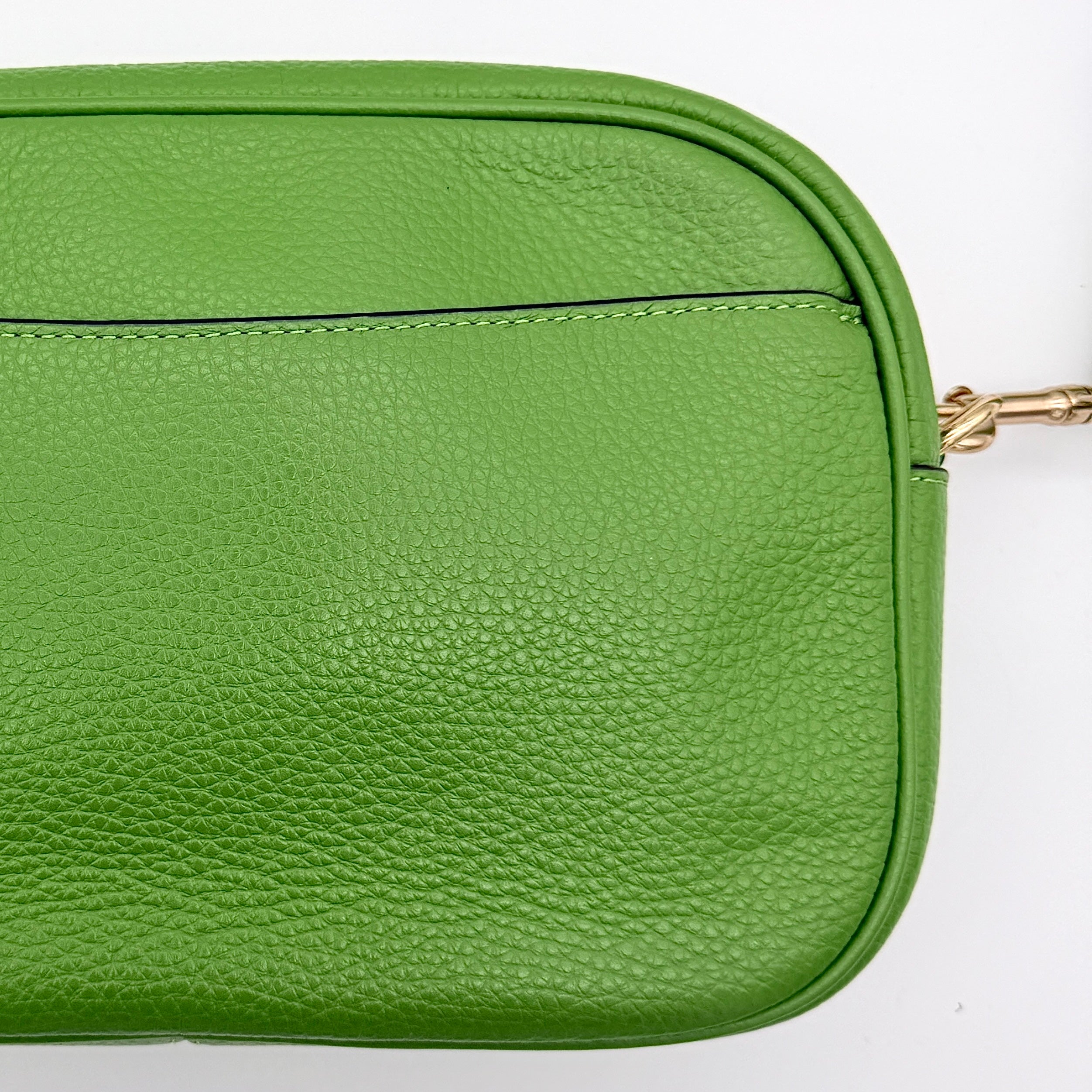 Coach Jamie Camera Crossbody Bag in green textured leather with gold-tone hardware and adjustable strap.