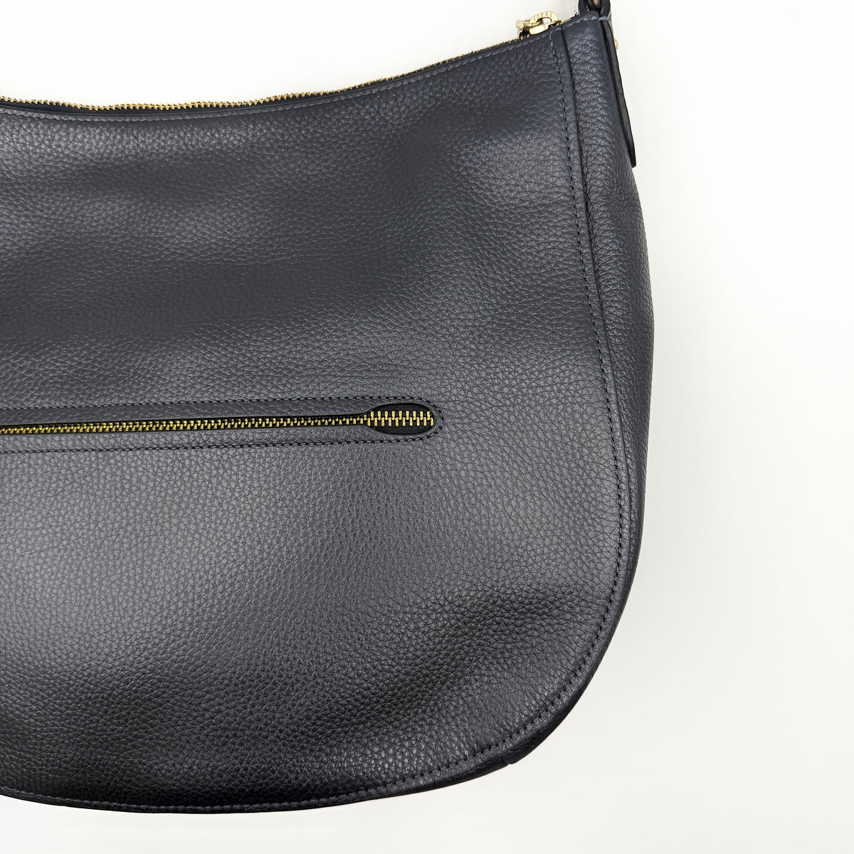 Coach Elle Hobo bag in navy blue pebbled leather with gold hardware and a detachable strap, styled on a white background.