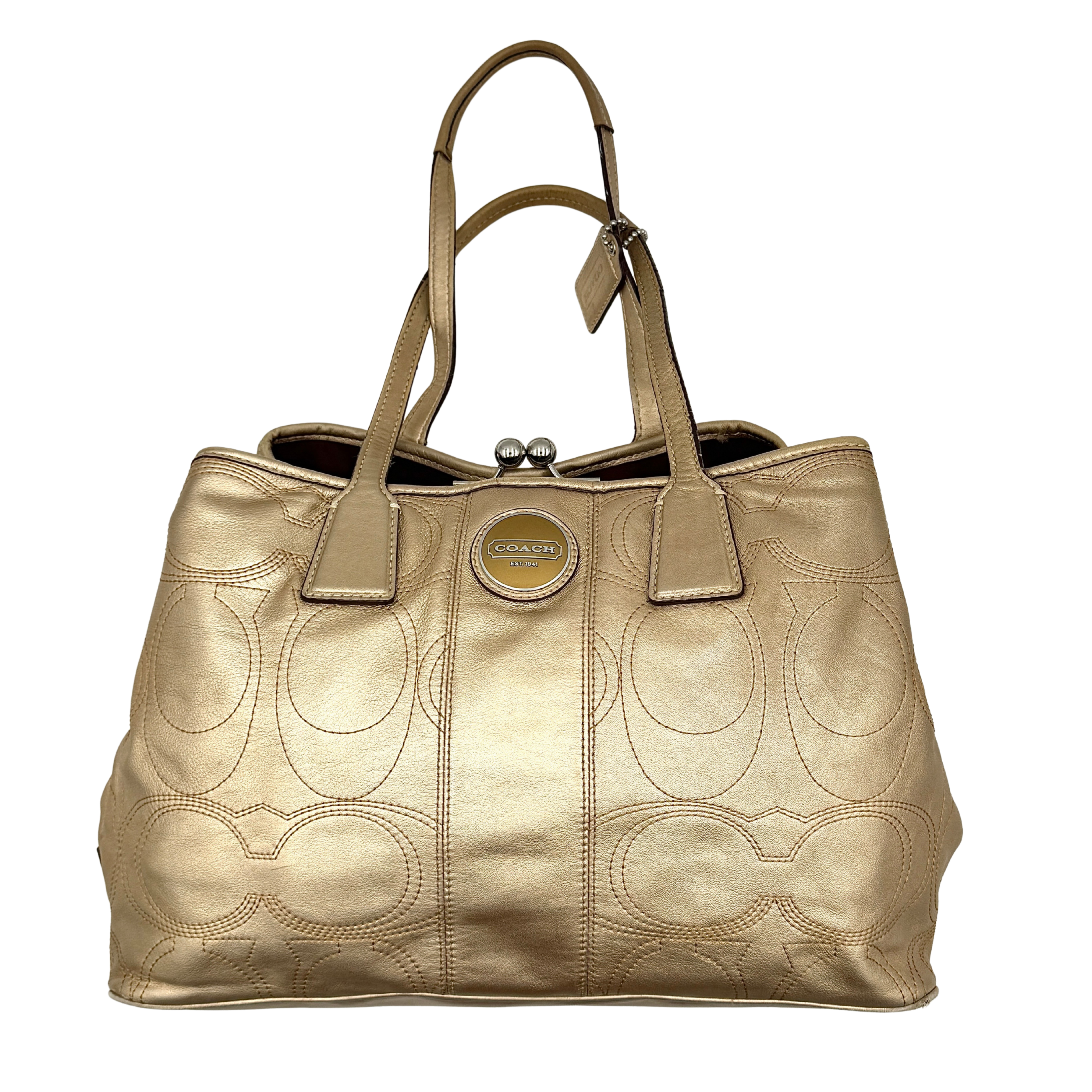 Coach metallic gold shoulder bag with signature embossed leather, double top handles, and a kisslock closure set against a clean background.