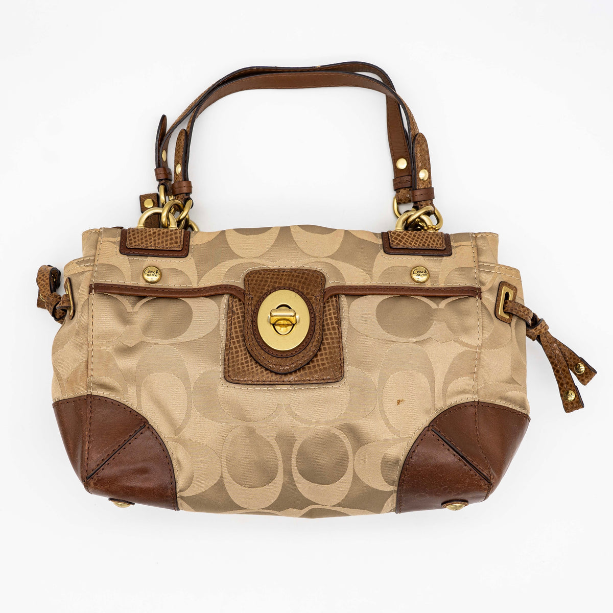 Coach Signature Peyton Shoulder Bag in brown sateen and leather with gold-tone hardware and turnlock pocket, photographed on a white background.