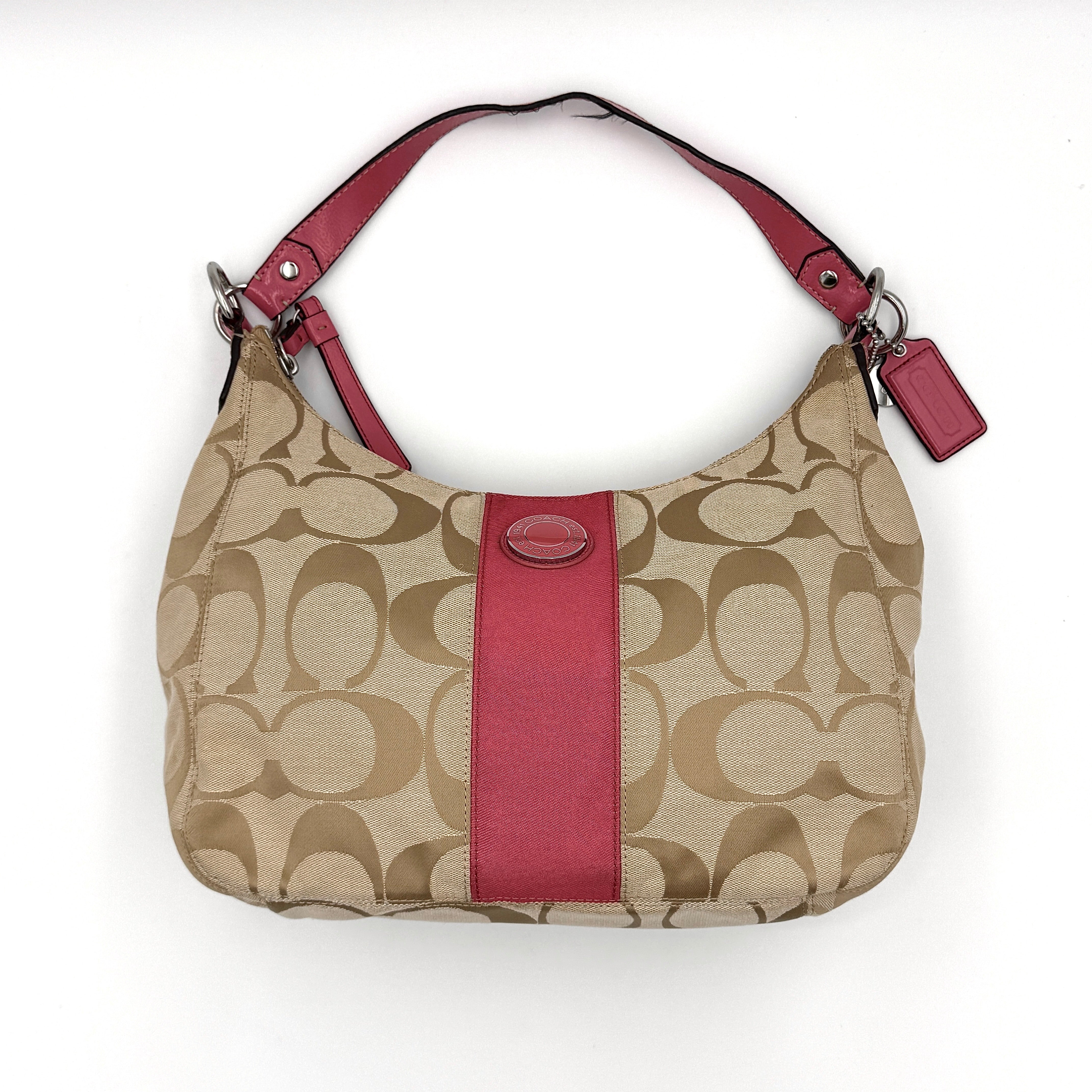 Coach Signature Stripe Hobo Shoulder Bag in beige jacquard canvas with bold pink central stripe and pink leather shoulder strap.