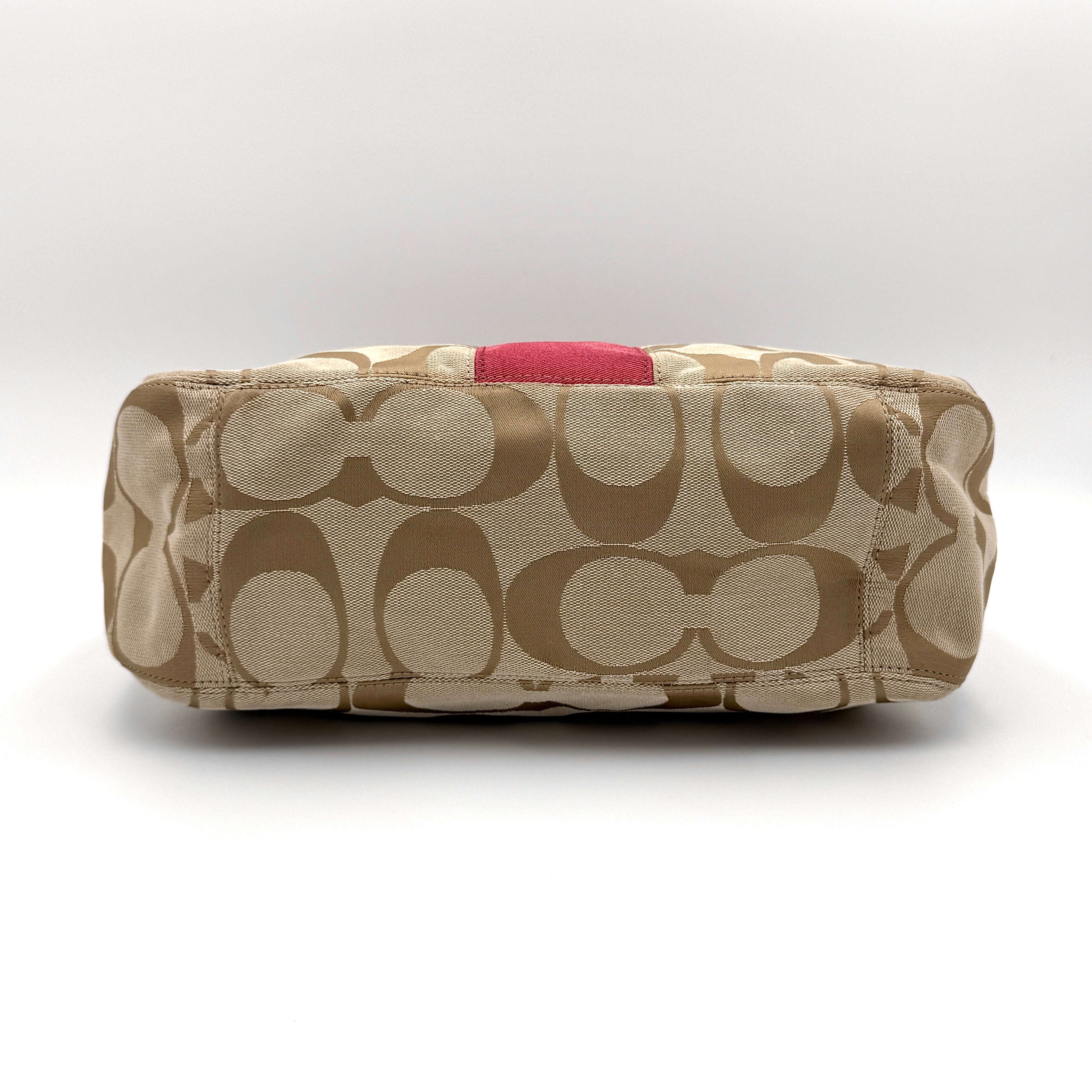 Coach Signature Stripe Hobo Shoulder Bag in beige jacquard canvas with bold pink central stripe and pink leather shoulder strap.