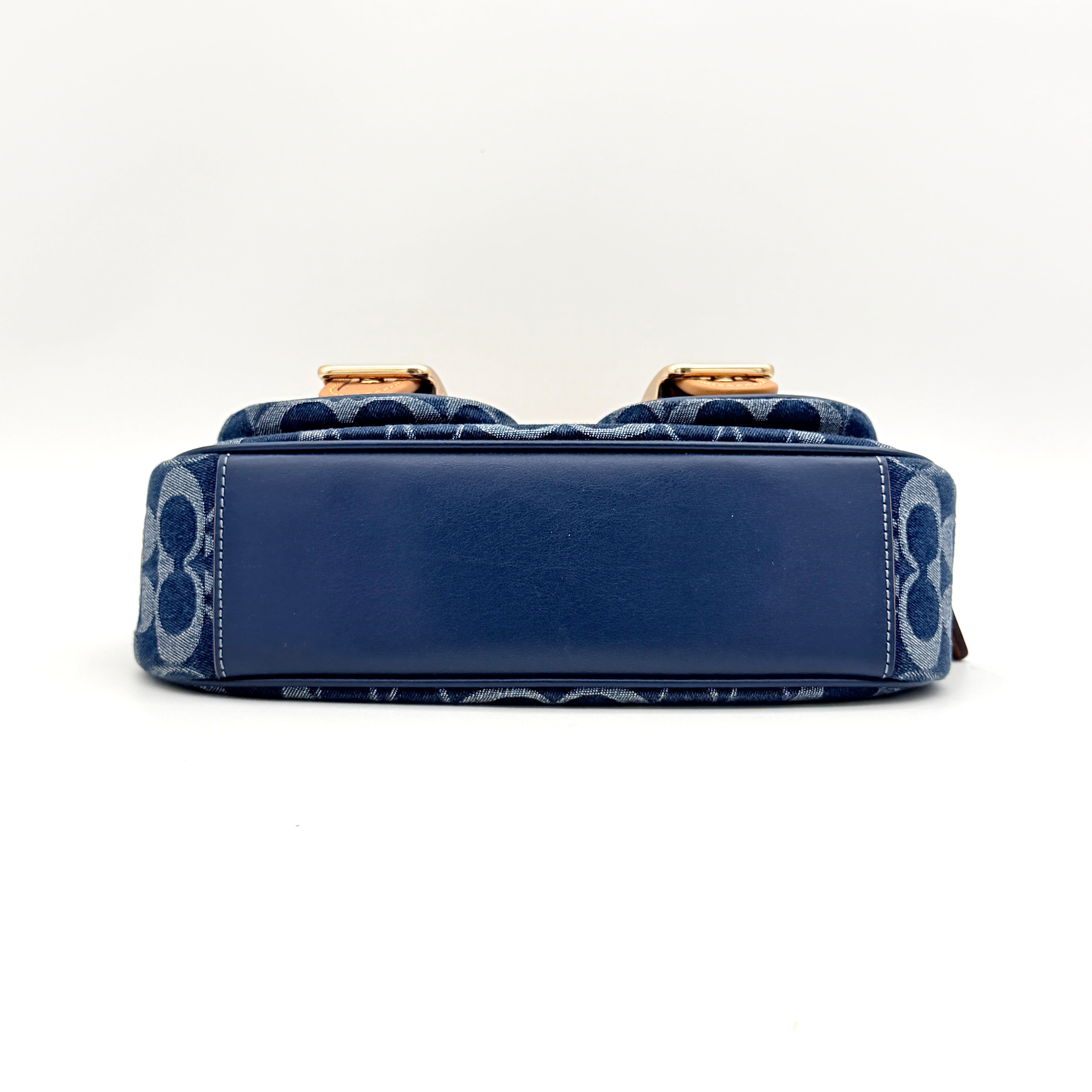 Coach Signature Ashton shoulder bag in blue denim and tan leather with gold hardware, shown with removable strap and dust bag.