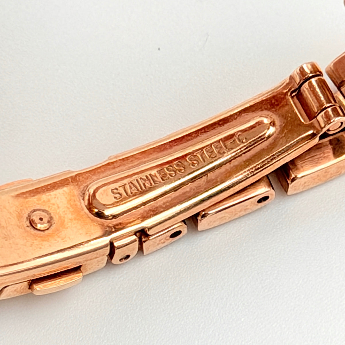 Front view of the Seiko Tisse Nozomi Special Edition watch with a pink heart motif dial and two-tone gold and rose gold bracelet.