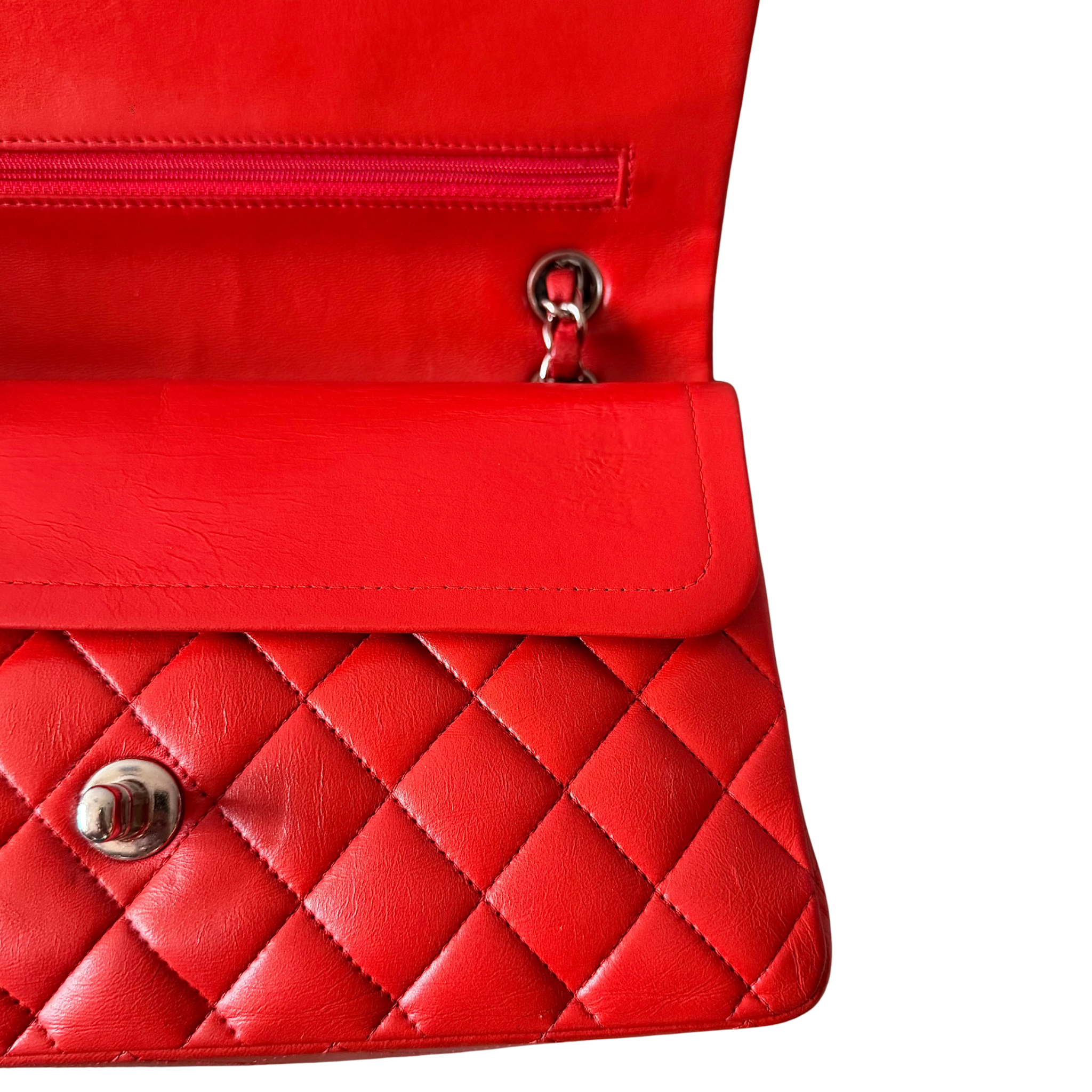 Chanel double flap shoulder bag in quilted red leather with silver-tone hardware and chain leather strap.