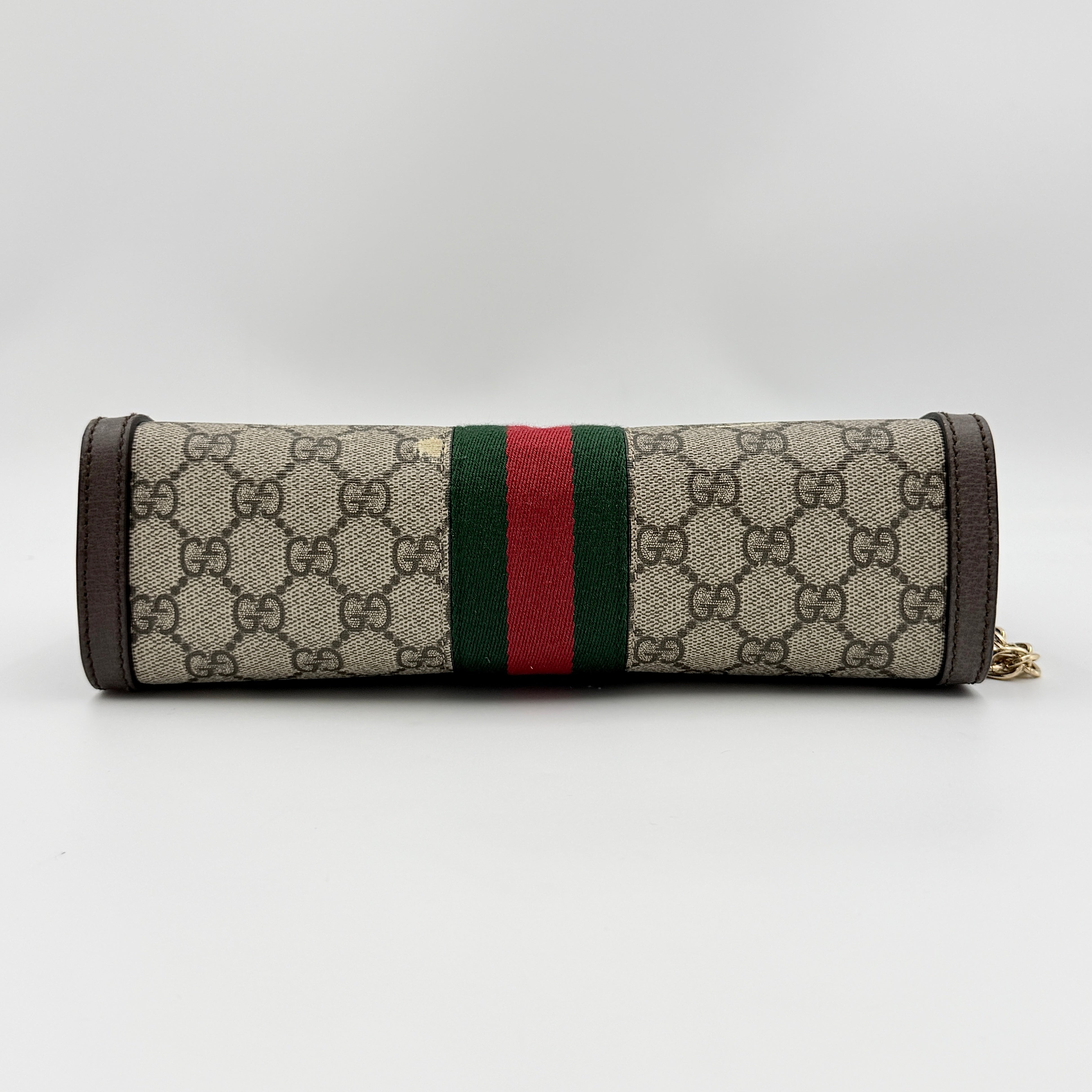 Gucci Ophidia GG Supreme crossbody bag in beige canvas with brown leather trim, signature web stripe, and gold chain strap.