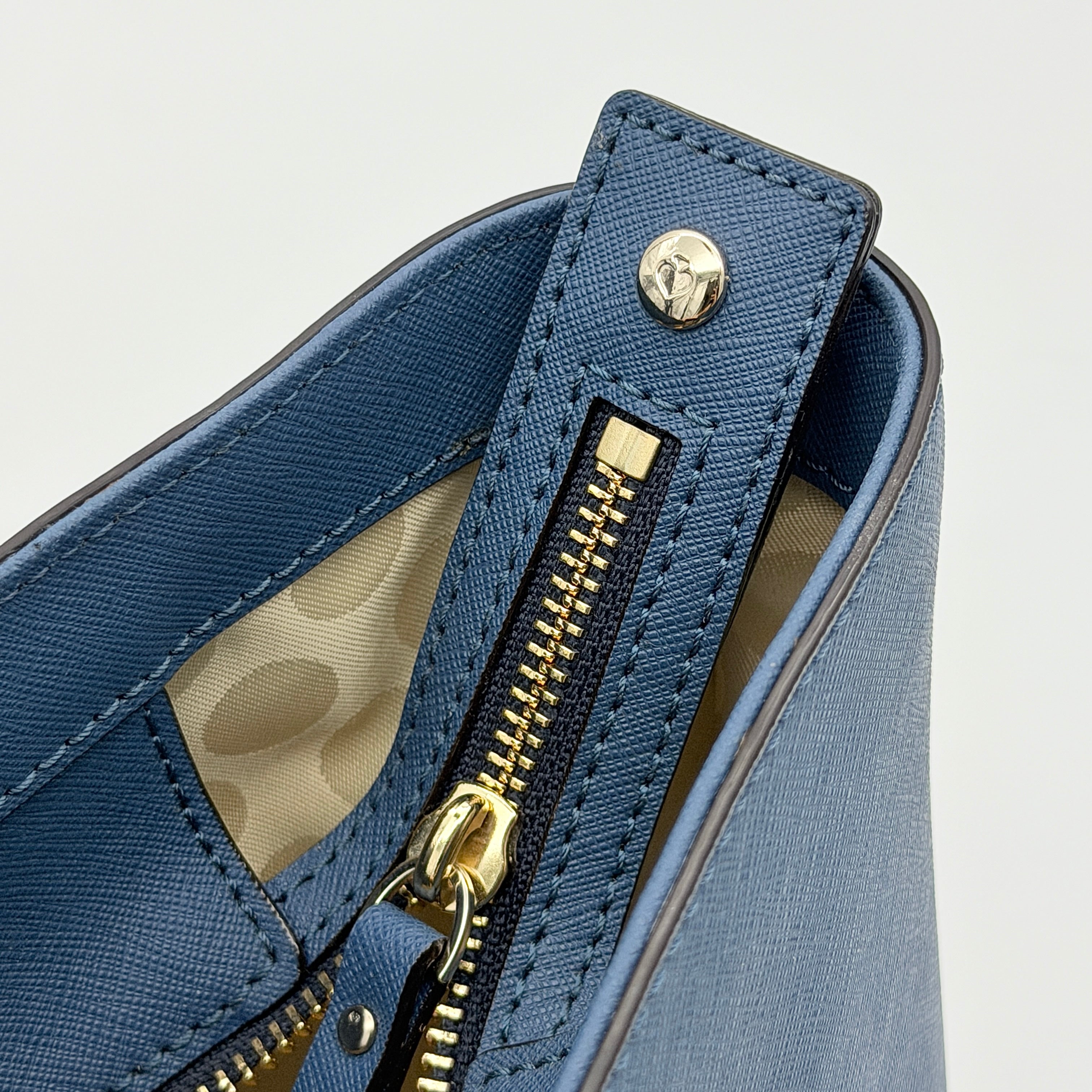Kate Spade New York leather tote in two-tone blue with gold-tone hardware and structured handles.