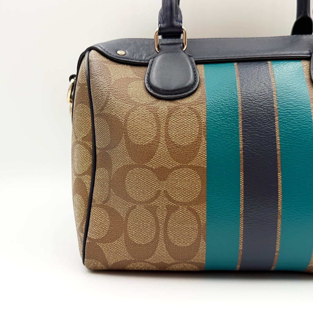 Coach Signature Mini Bennett Boston Bag in monogram canvas with navy and teal varsity stripes and dark navy leather trim.