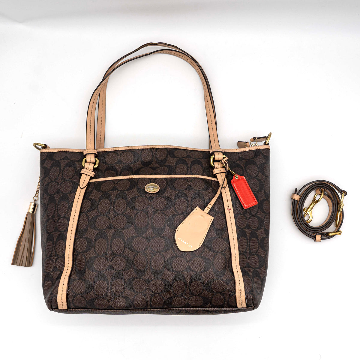 Coach Signature Peyton Pocket tote bag in brown canvas with tan leather trim, shown with both handles and detachable strap.