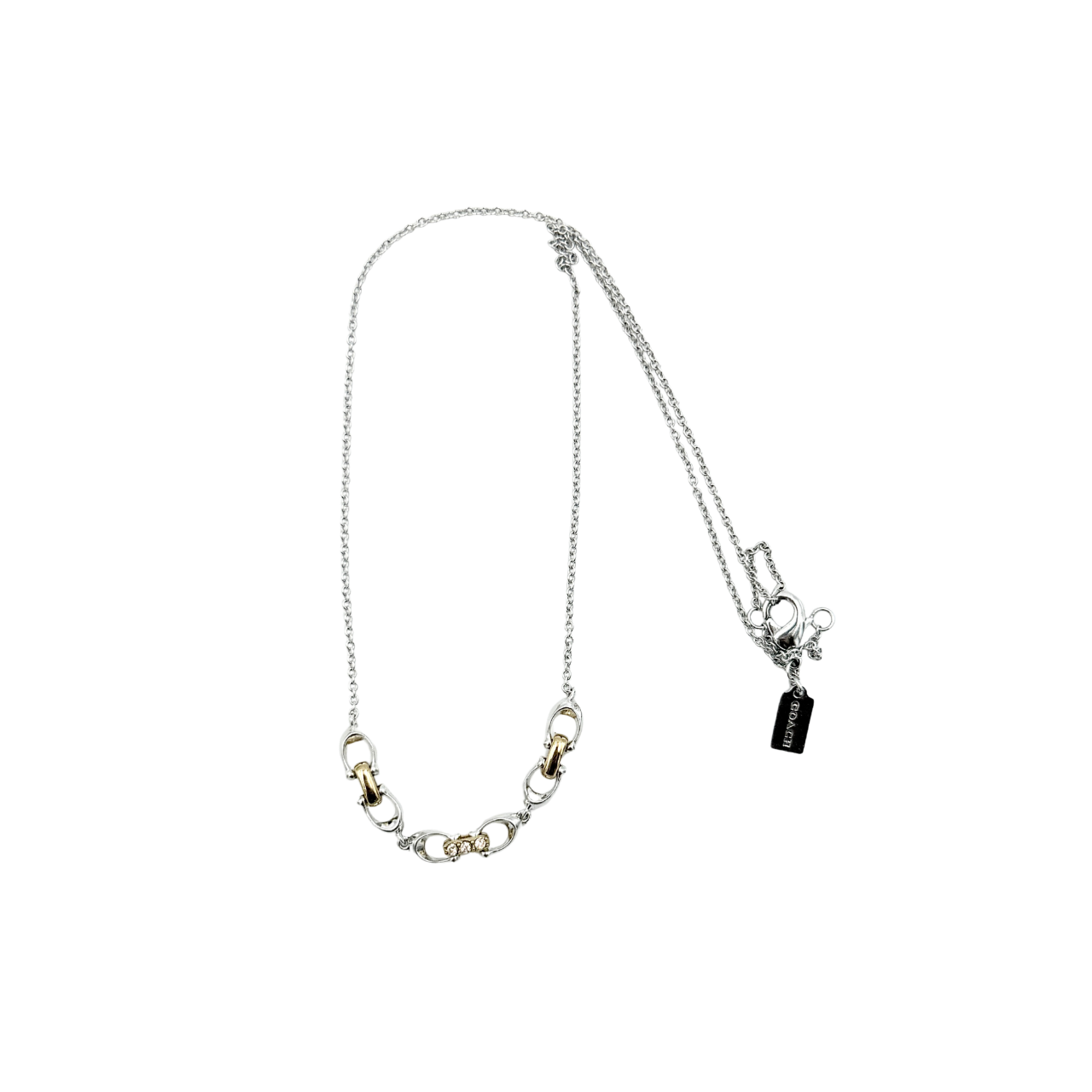 Coach Signature Linked Necklace in silver and gold tones featuring sculptural mixed-metal links and a central crystal accent.