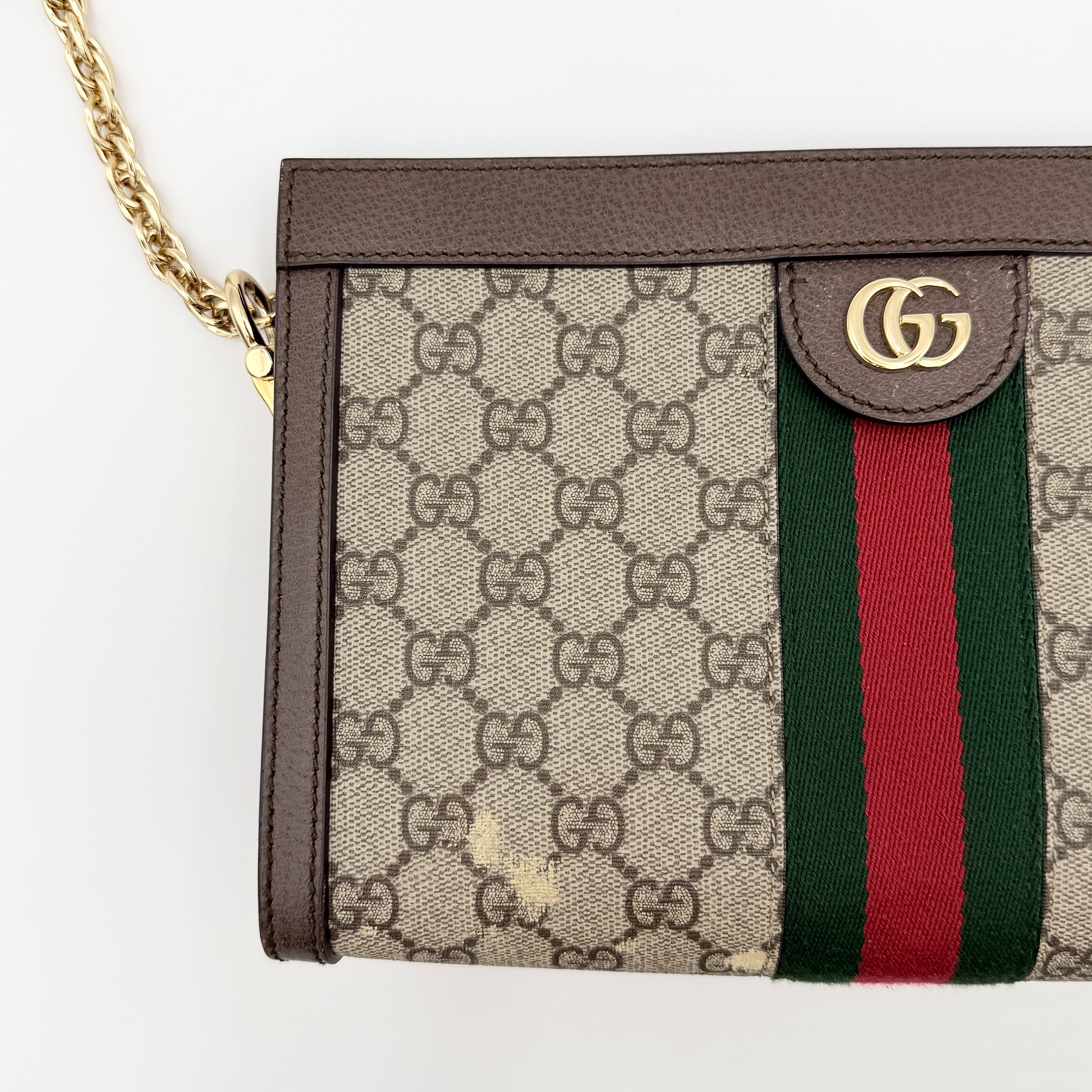 Gucci Ophidia GG Supreme crossbody bag in beige canvas with brown leather trim, signature web stripe, and gold chain strap.
