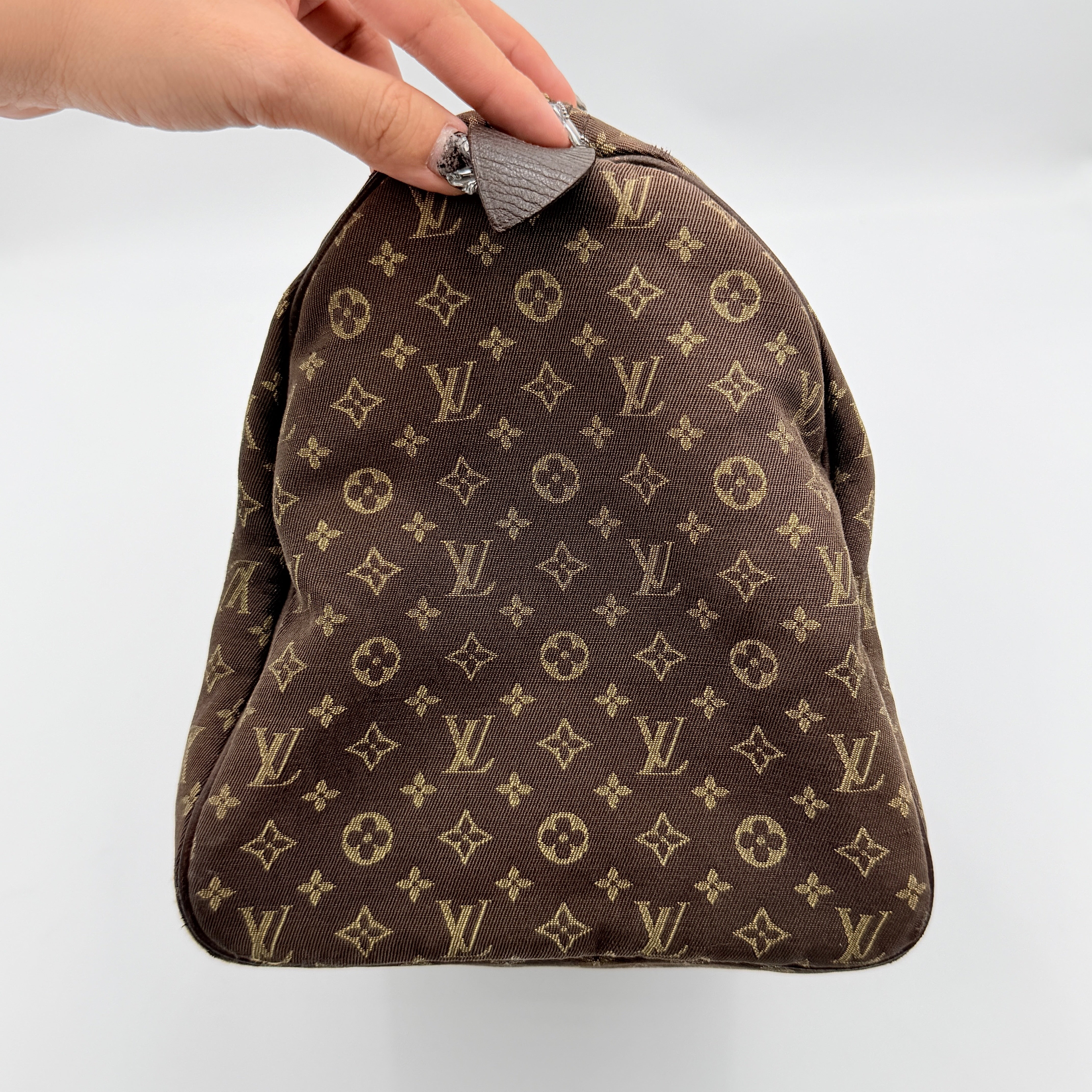 Louis Vuitton Monogram Mini Lin Speedy 30 in brown textile with top handles and monogram motif, shown against a white background.
