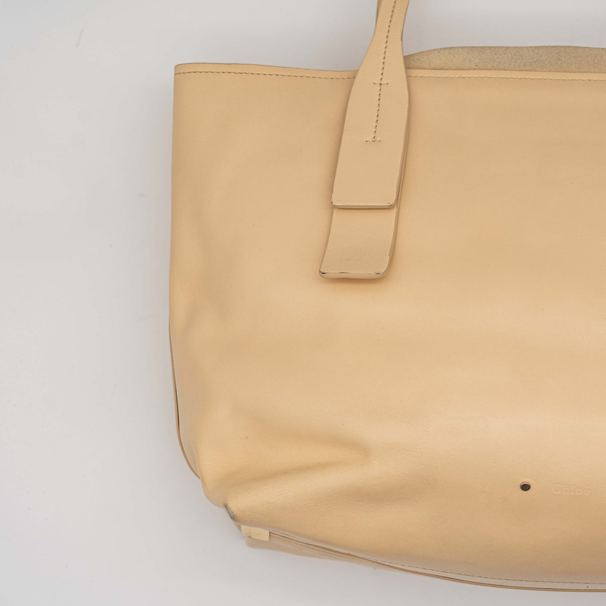 Chloé C Zipped Tote Bag in beige leather with gold hardware, shown with structured dual straps and front logo detail.