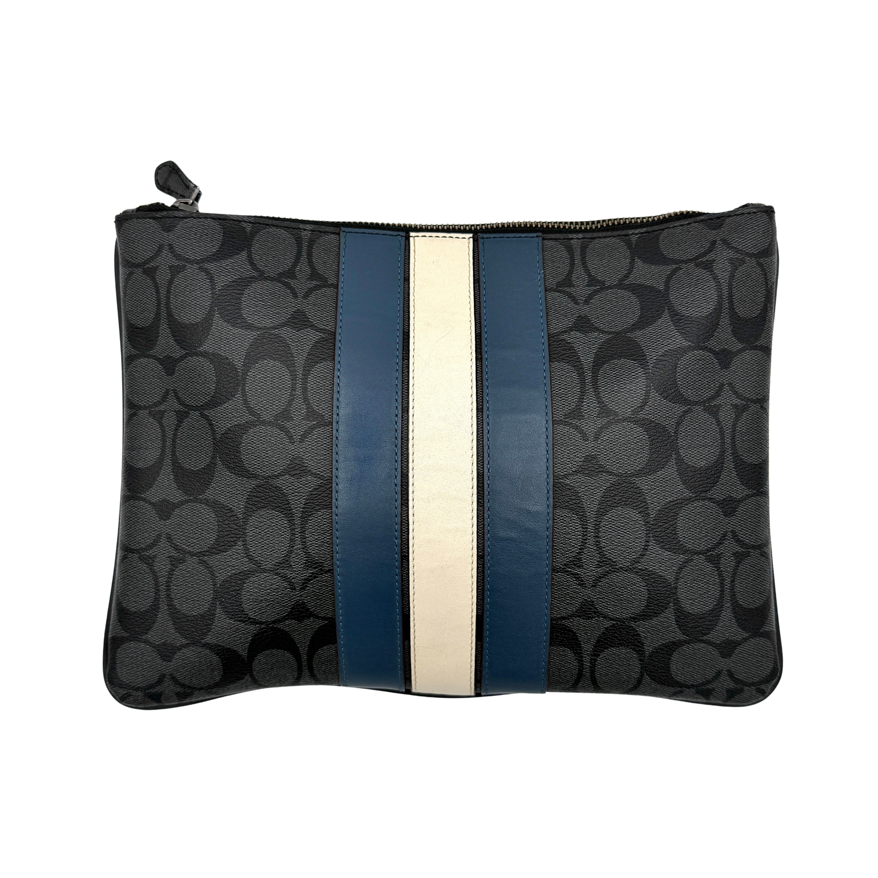 Coach Signature large pouch in black coated canvas with navy and cream varsity stripes, shown from the front with a zip top.