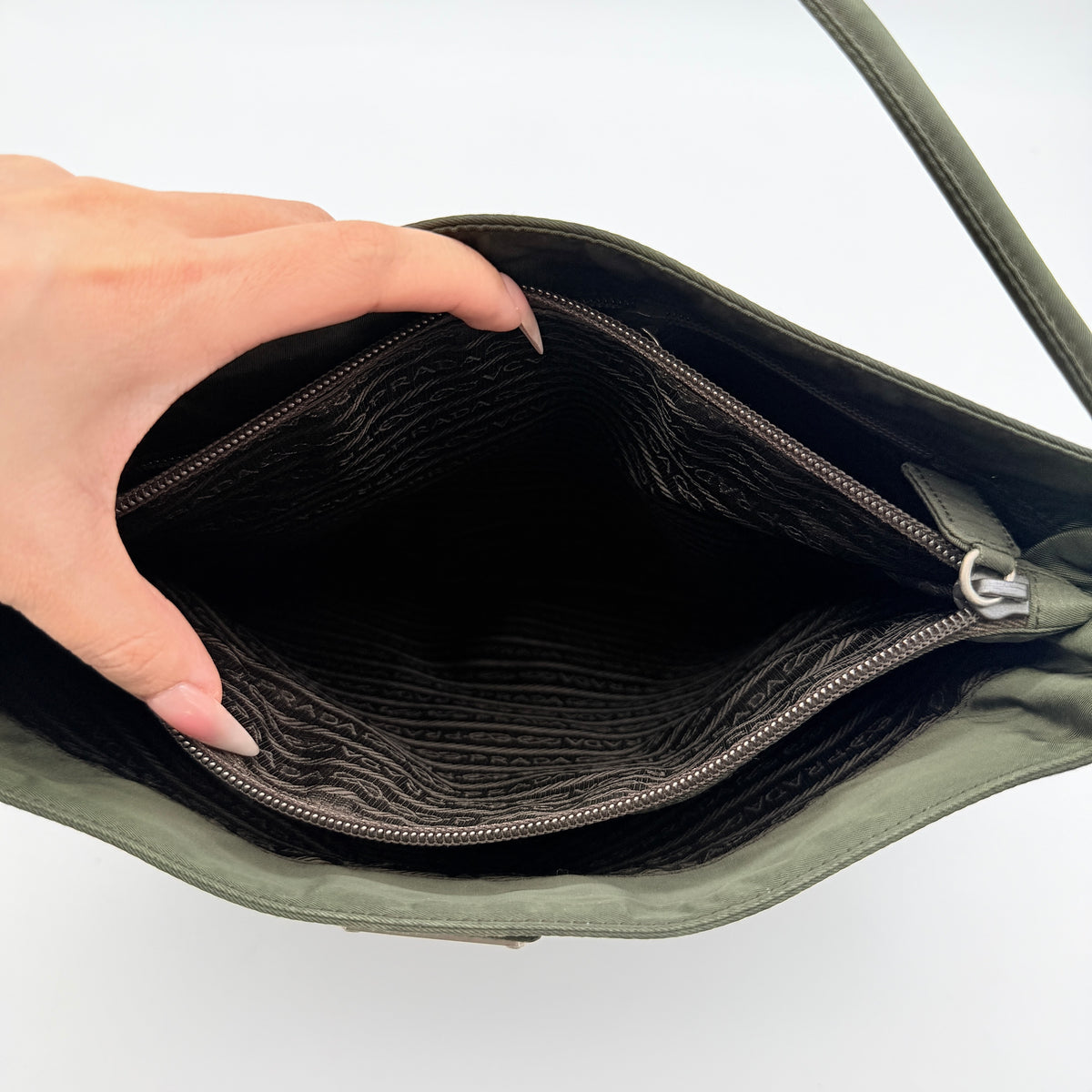 Prada Tessuto Nylon City Tote Bag in dark green nylon with double handles and signature triangle logo plaque on the front.