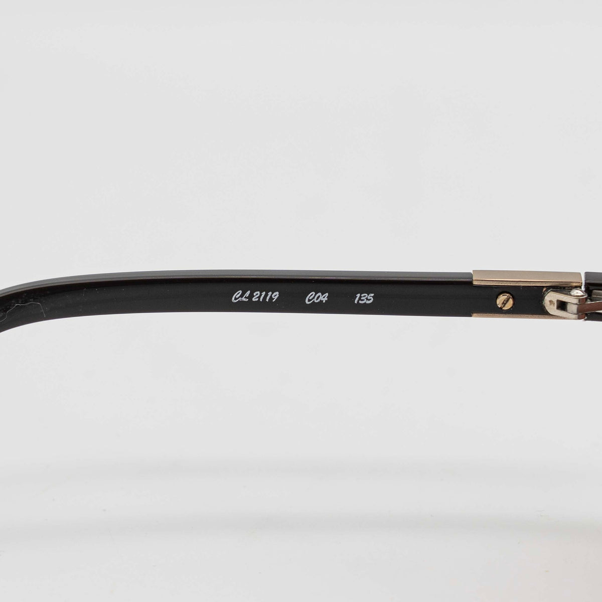 Chloé CL2119 sunglasses in black with gold-tone accents and brown gradient lenses, displayed at an angle.