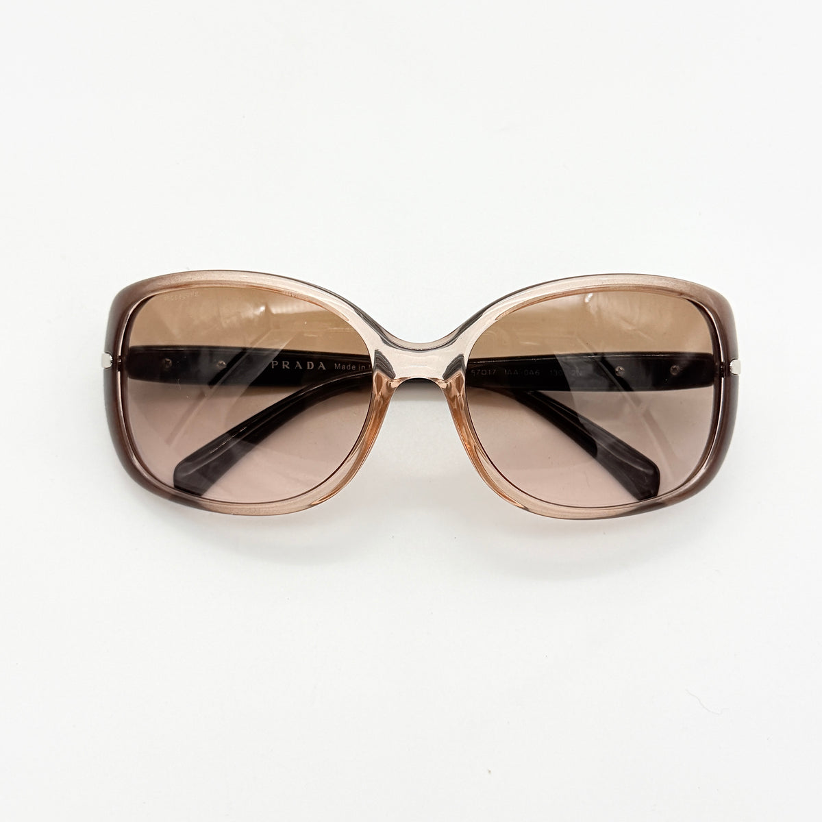 Prada SPR080 sunglasses featuring a brown and blush oversized frame with gradient lenses and silver hardware at the temples.