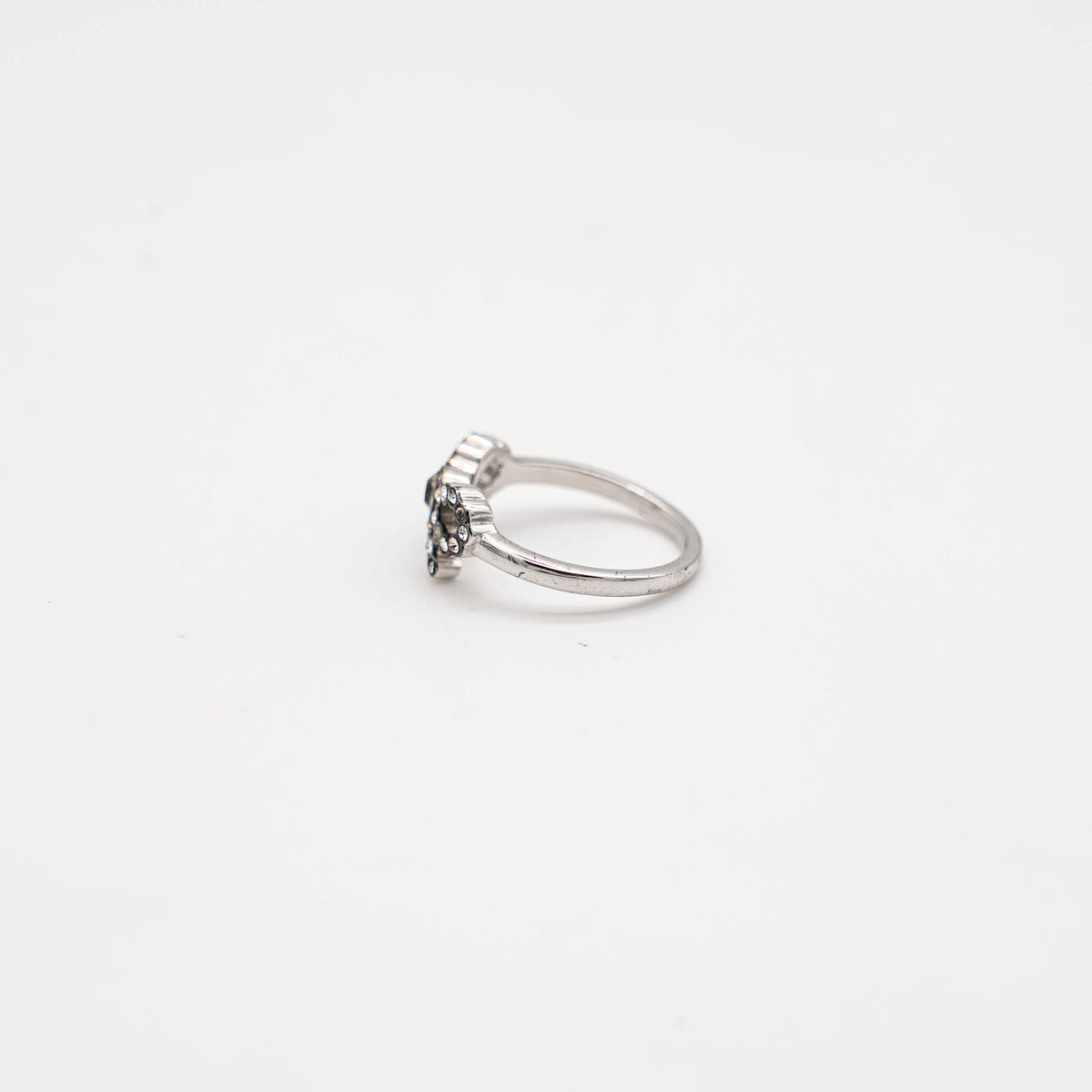 Coach silver ring with a rhinestone-encrusted bow motif, photographed against a white background.