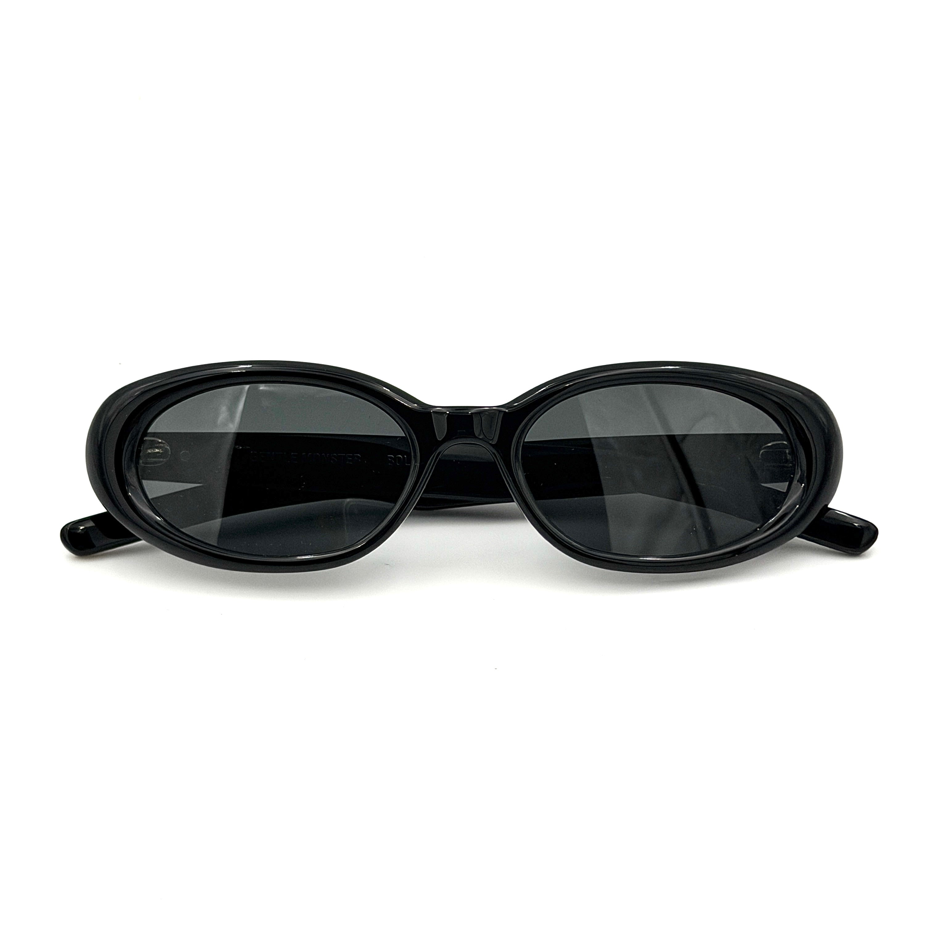 Gentle Monster Bandoneon.S sunglasses in black acetate with dark oval lenses and silver star accents shown from the side.
