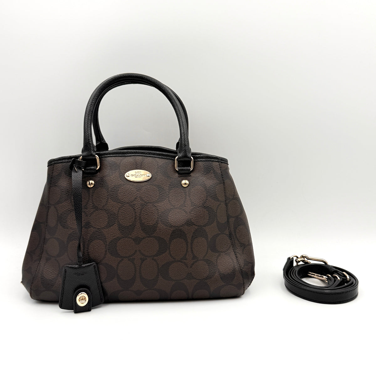 Coach 2Way Signature Margot Carryall Satchel in brown with black leather handles and gold hardware, shown with detachable strap.