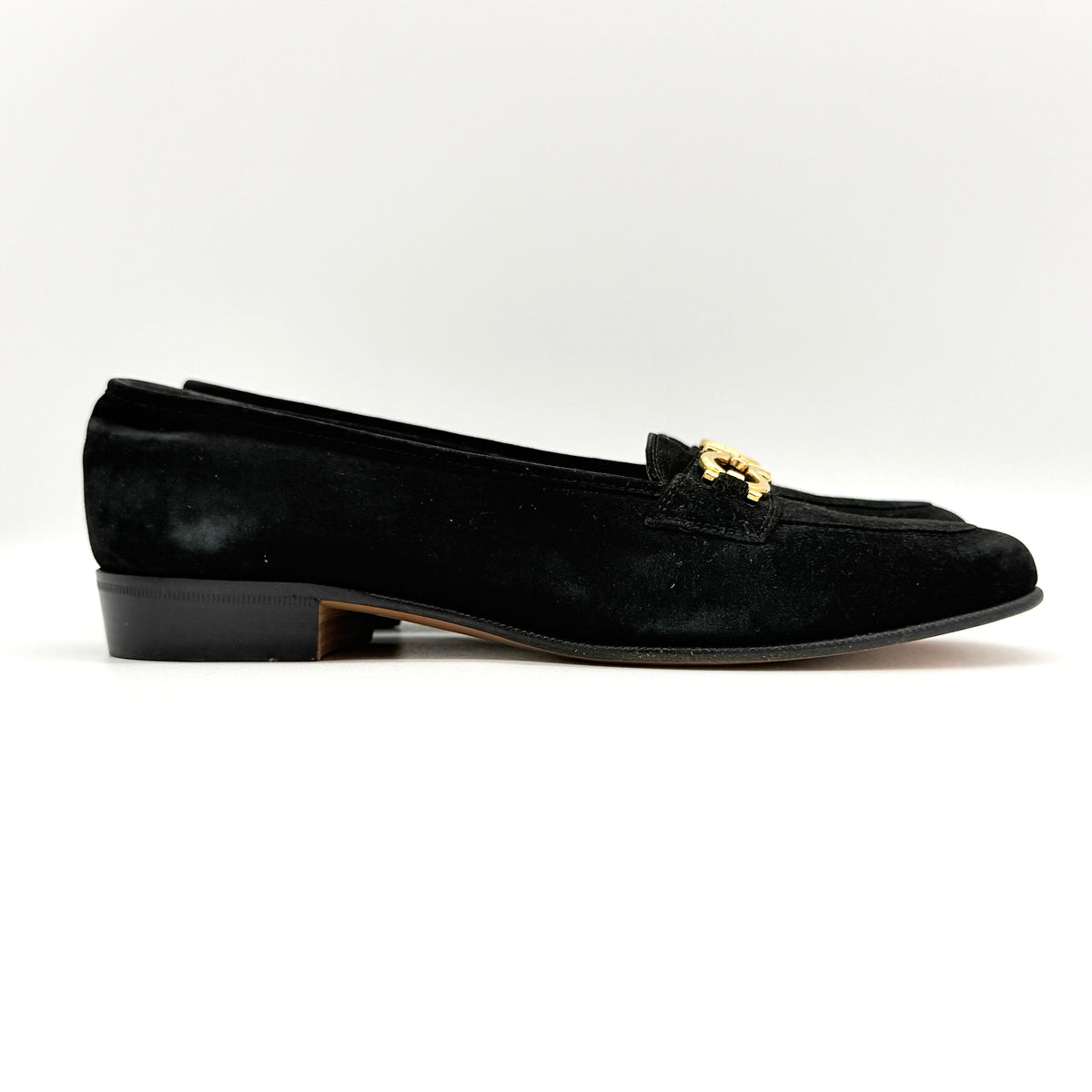 Salvatore Ferragamo black suede loafers with gold Gancini horsebit detail, displayed side by side on a white background.