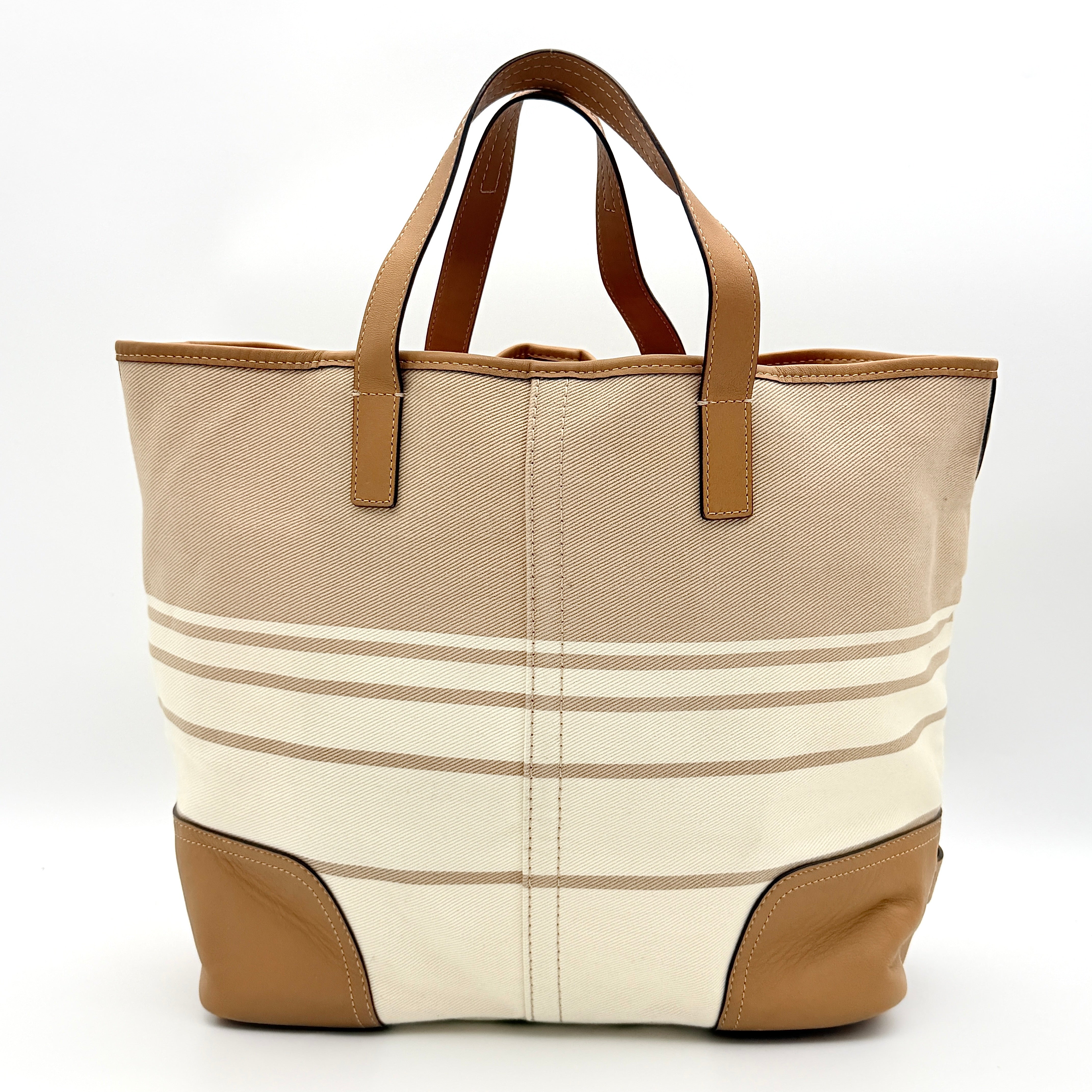 Coach Hadley Variegated Stripe Handbag in beige and tan canvas with leather trim, shown with top handles and detachable strap.