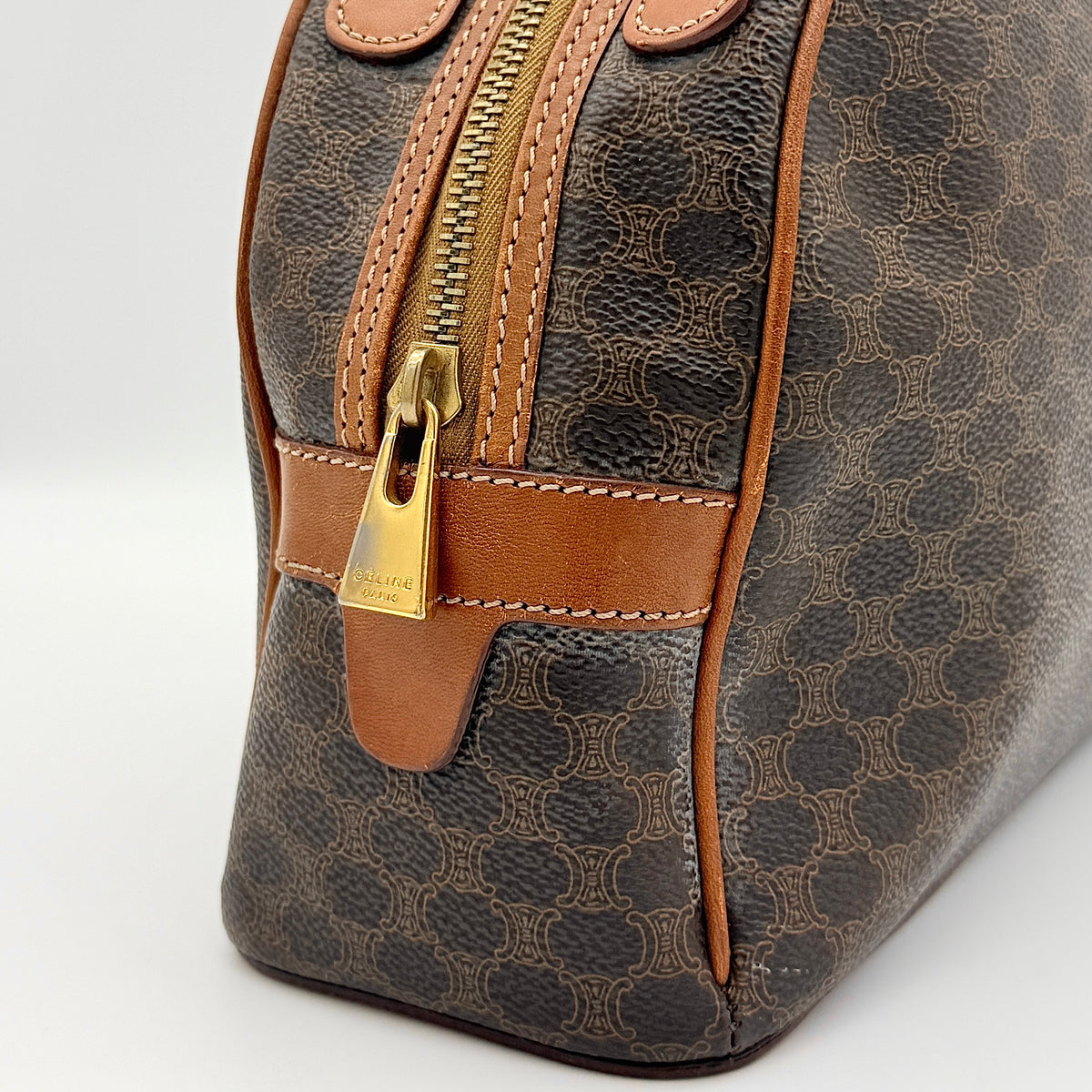 Front view of the Celine Triomphe Macadam Dome Handbag in brown, featuring the signature monogram canvas and tan leather details.