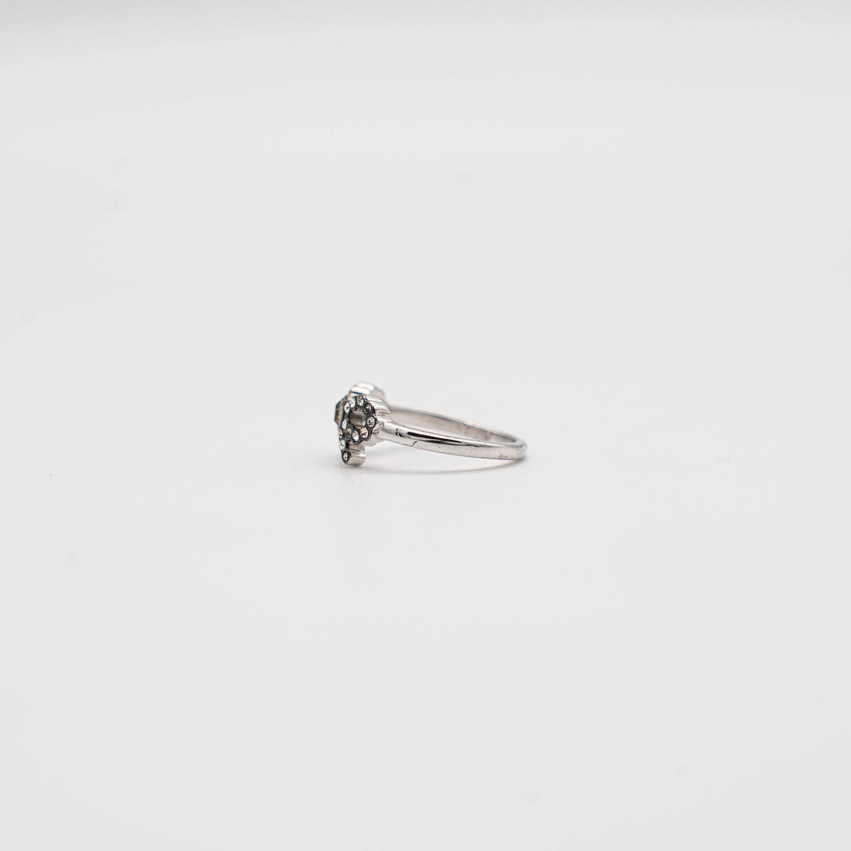 Coach silver ring with a rhinestone-encrusted bow motif, photographed against a white background.