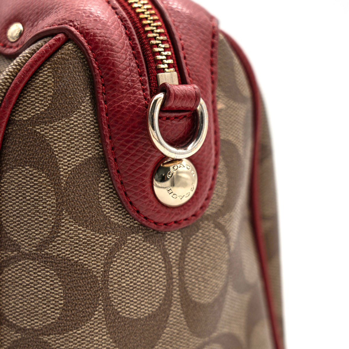 Coach Mini Bennett Boston bag in signature beige canvas with red leather trim, shown with detachable crossbody strap.