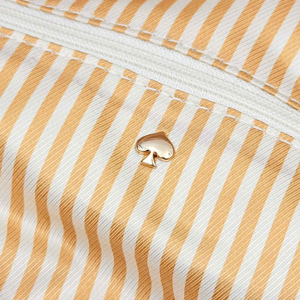 Kate Spade Cobble Hill Little Minka in beige pebbled leather with both top handle and detachable strap displayed.