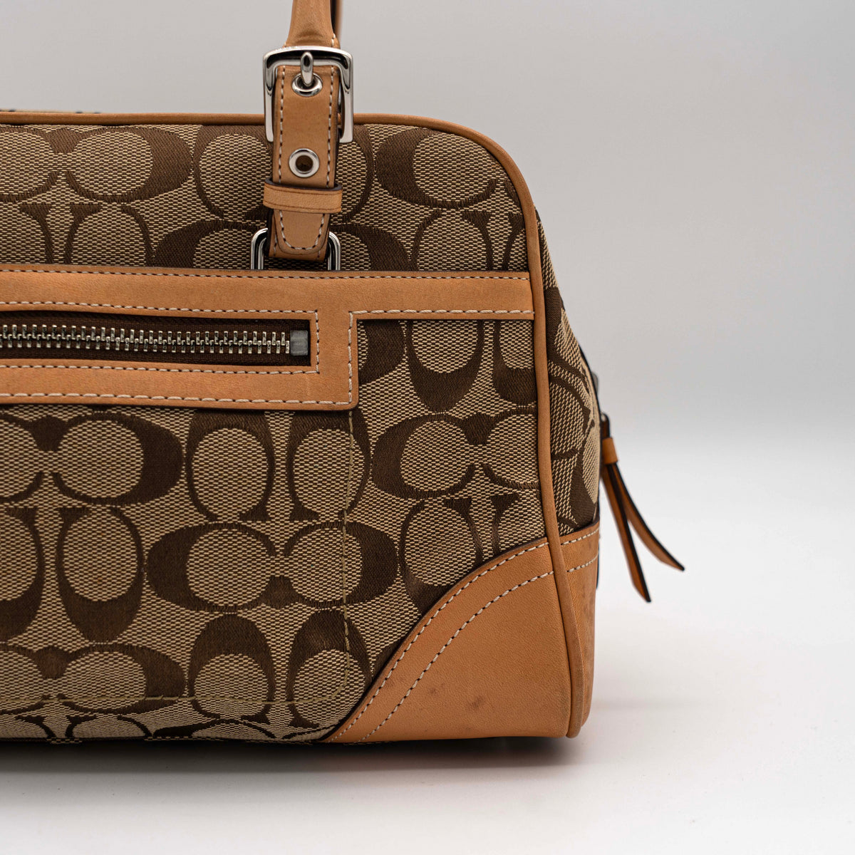 Coach Signature Hampton Satchel Boston Bag in beige and tan canvas with leather trim and silver hardware, styled on a clean background.