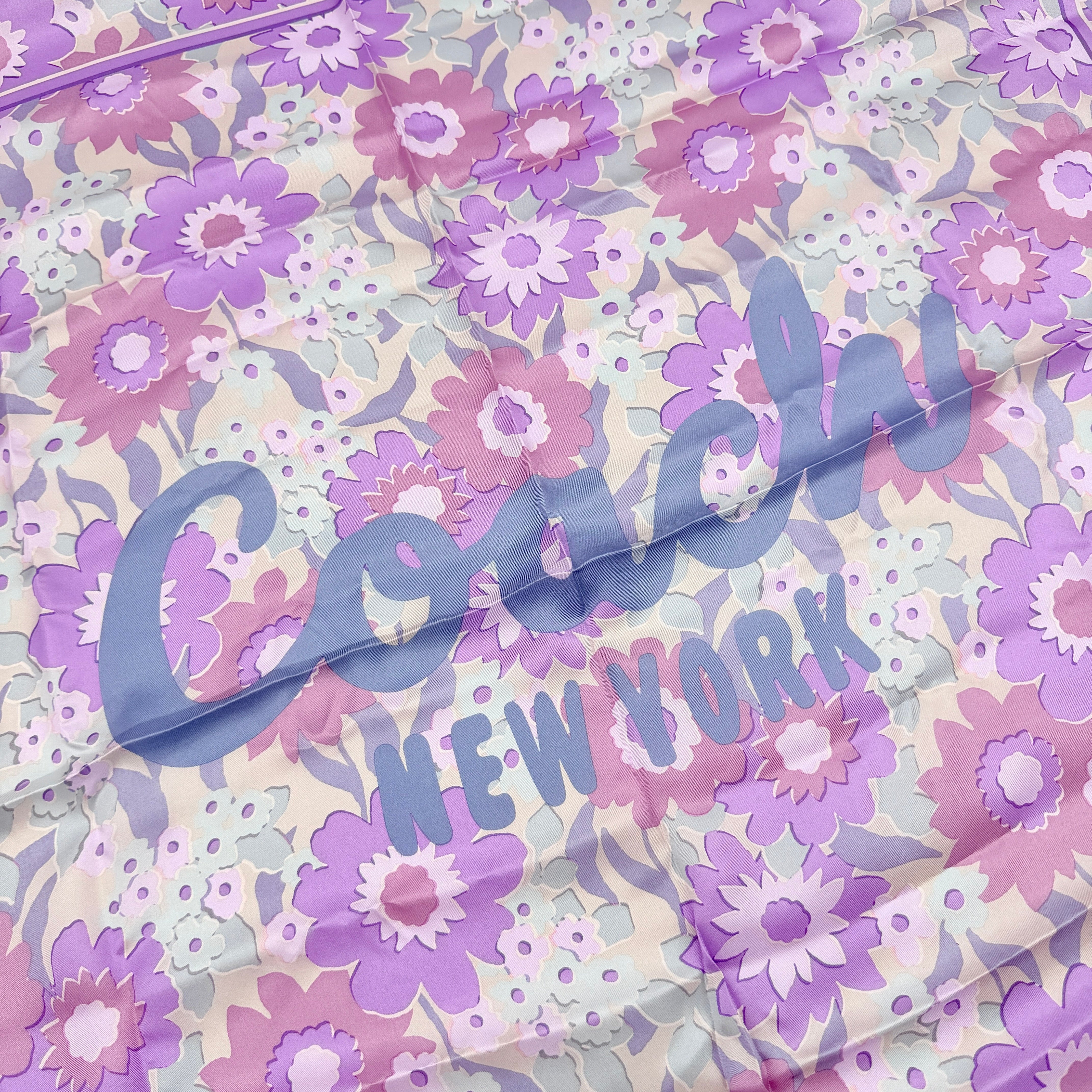 Coach floral silk scarf in purple with logo, presented with original packaging and tags.
