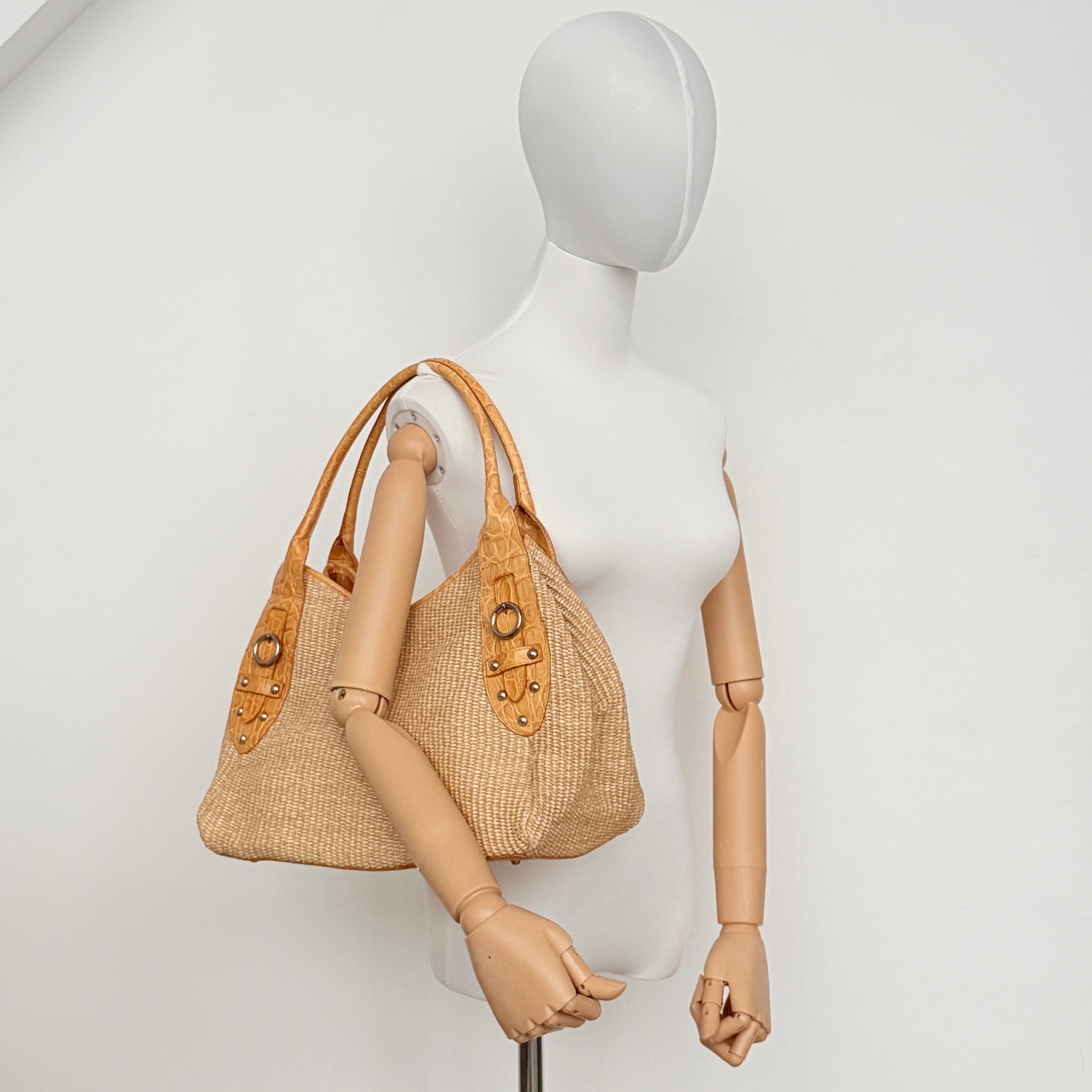 Front view of the Furla raffia and tan leather tote bag featuring silver-tone hardware and woven texture.