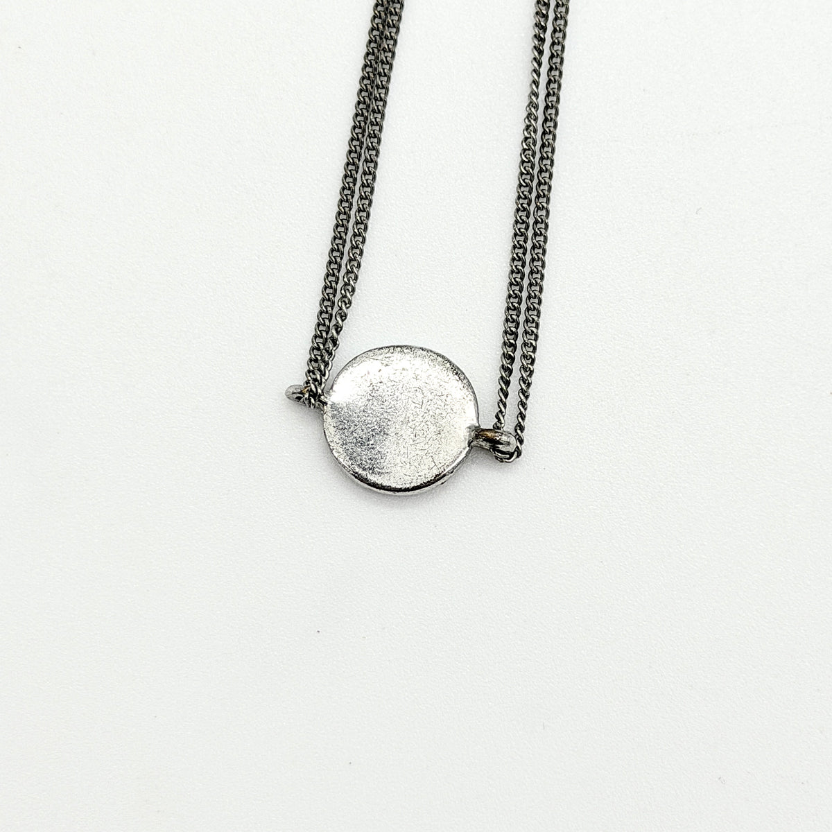 Christian Dior silver double chain bracelet with Dior logo medallion and adjustable clasp.