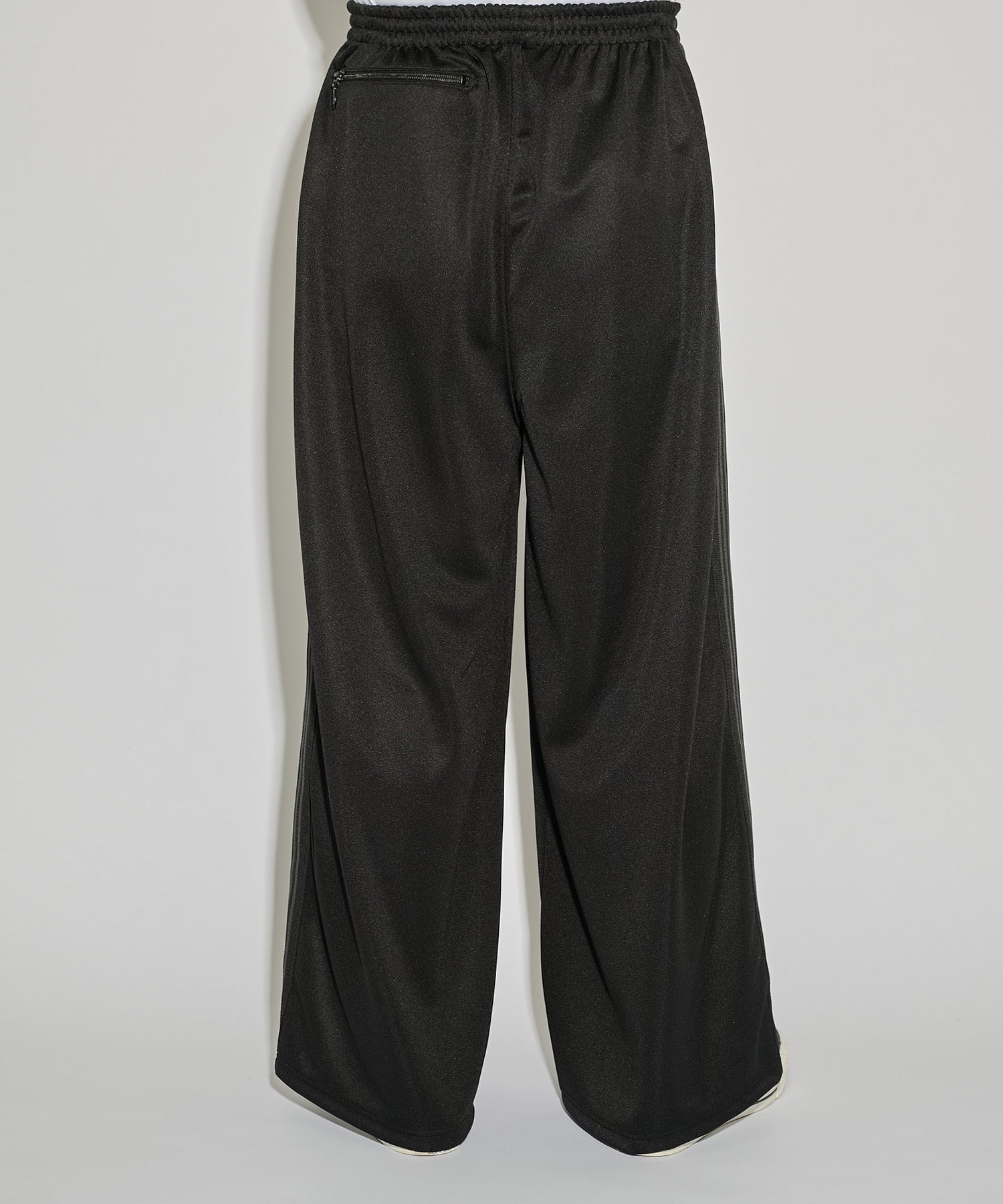 Needles H.D. Track Pant in black with tonal butterfly embroidery and relaxed wide-leg cut, photographed on model.