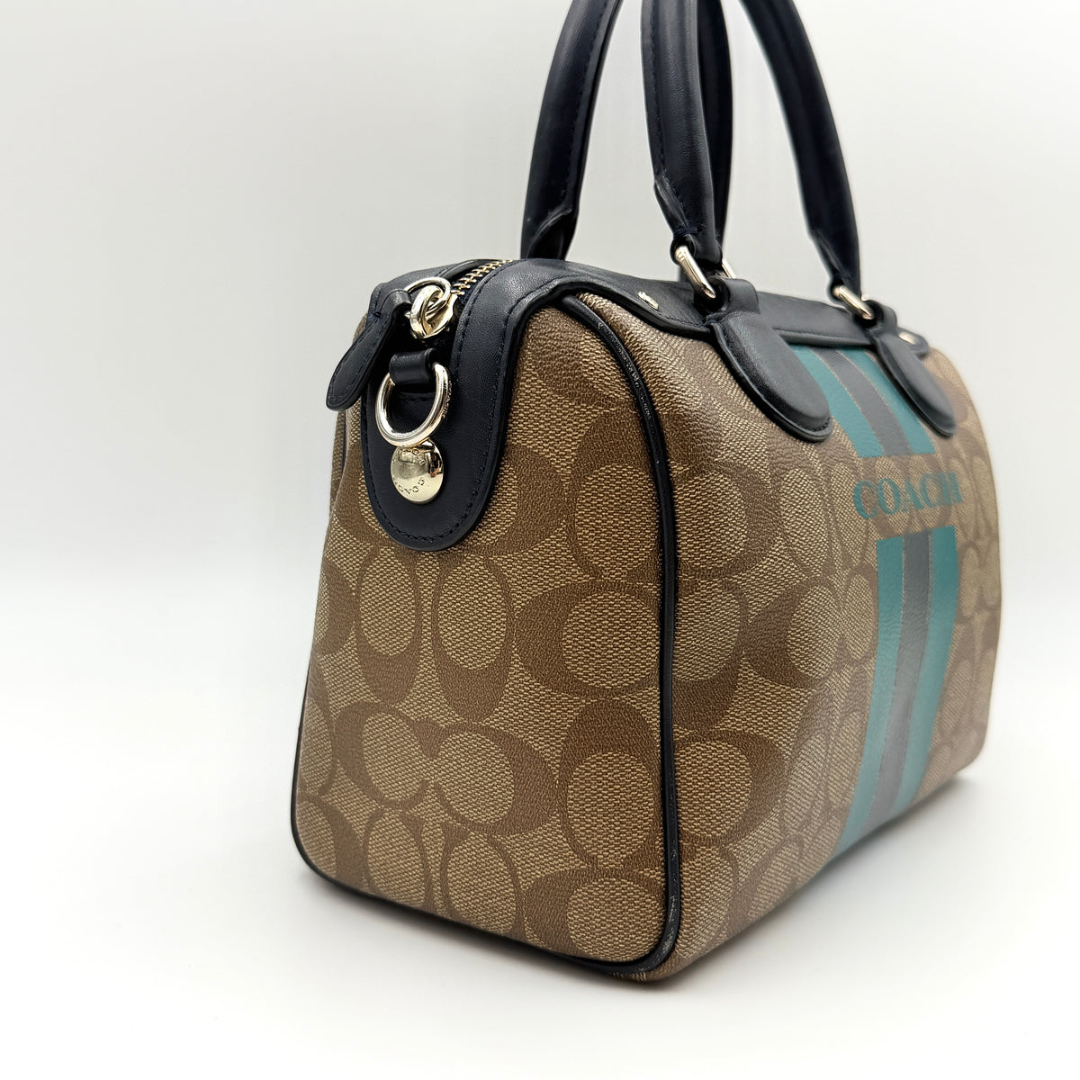 Coach Signature Mini Bennett Boston Bag in monogram canvas with navy and teal varsity stripes and dark navy leather trim.