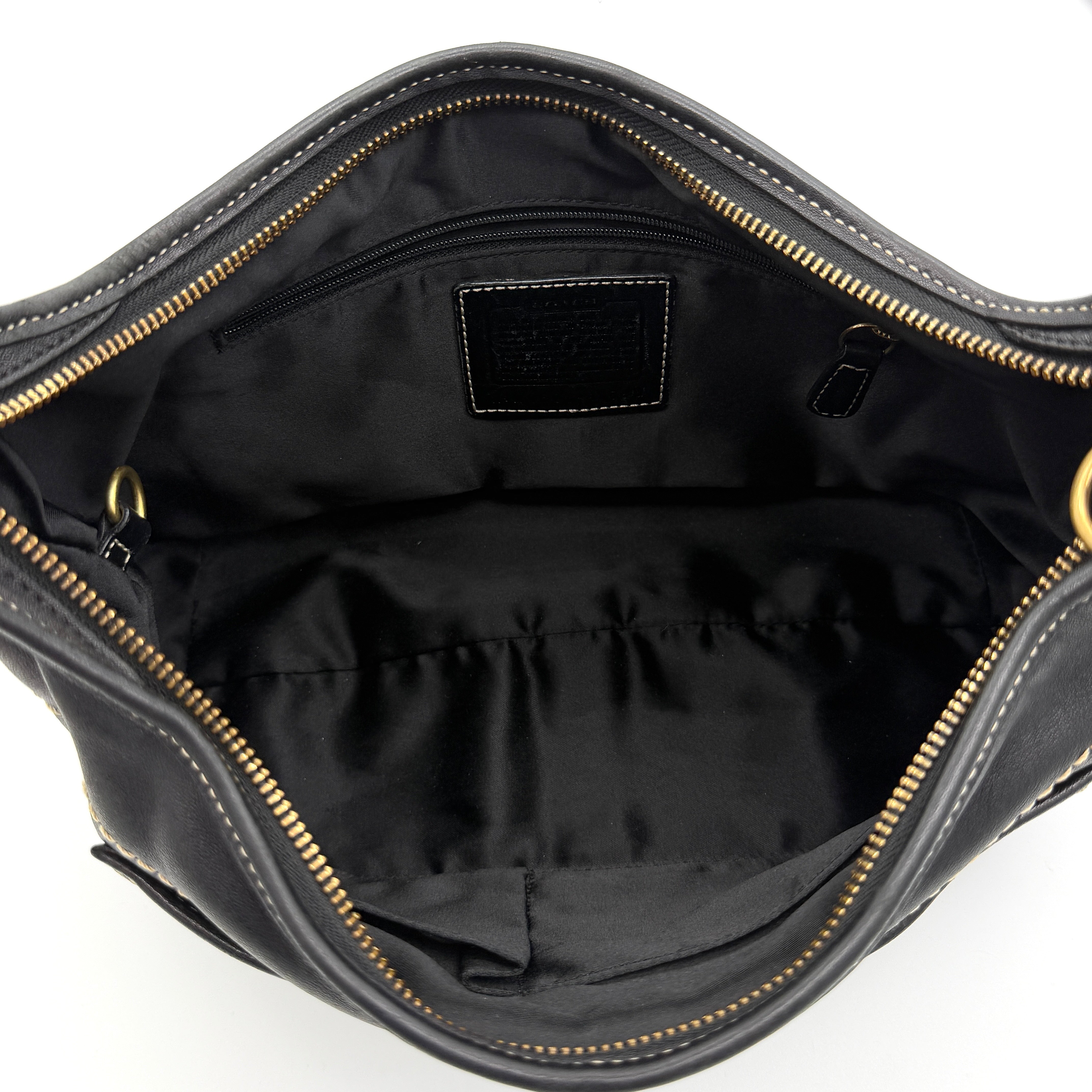 Coach Signature Ergo Hobo Shoulder Bag in black leather with contrast stitching and brass hardware, displayed against a white background.