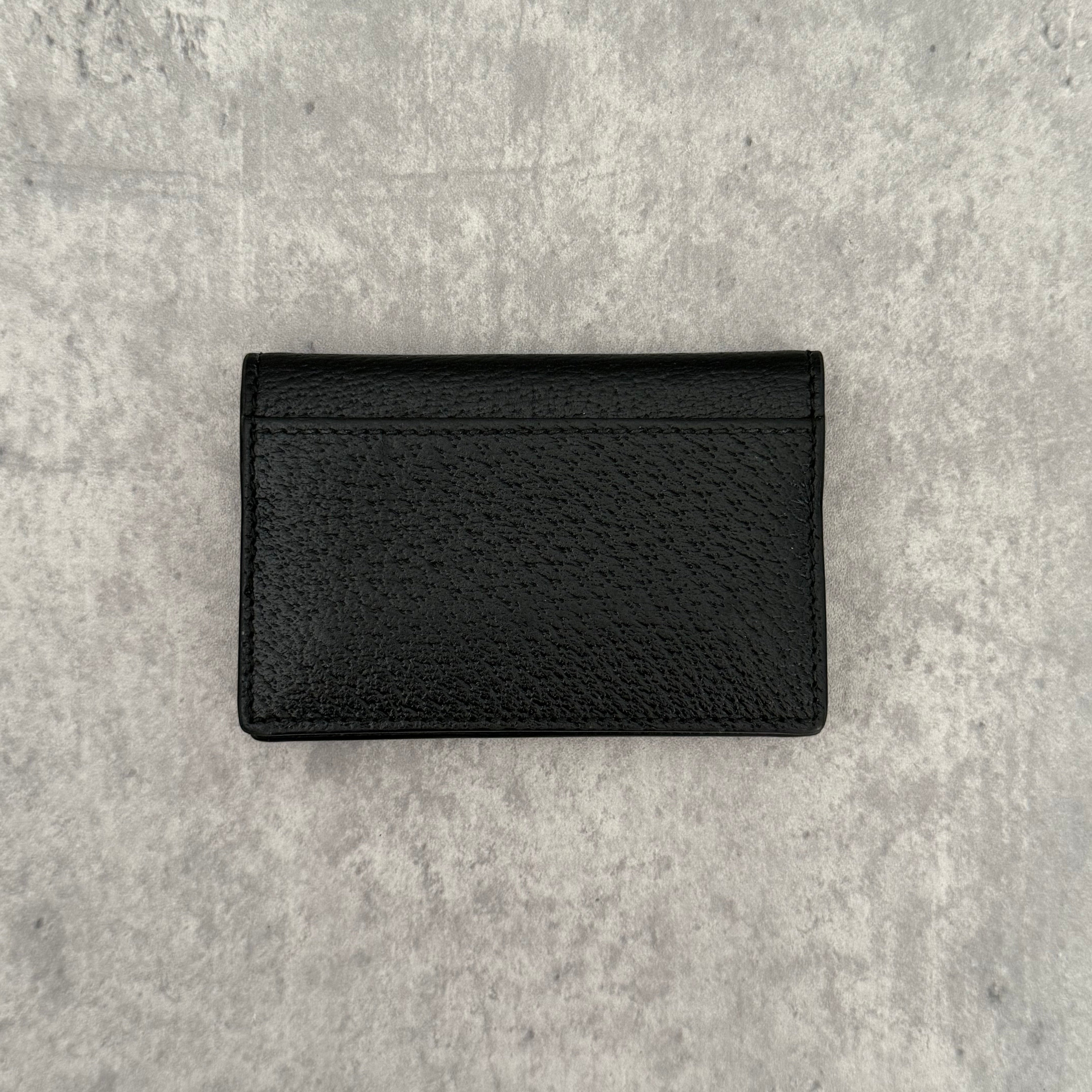 Gucci Interlocking G Black Leather Cardholder, featuring pebbled leather and silver-tone logo hardware in a slim bifold design
