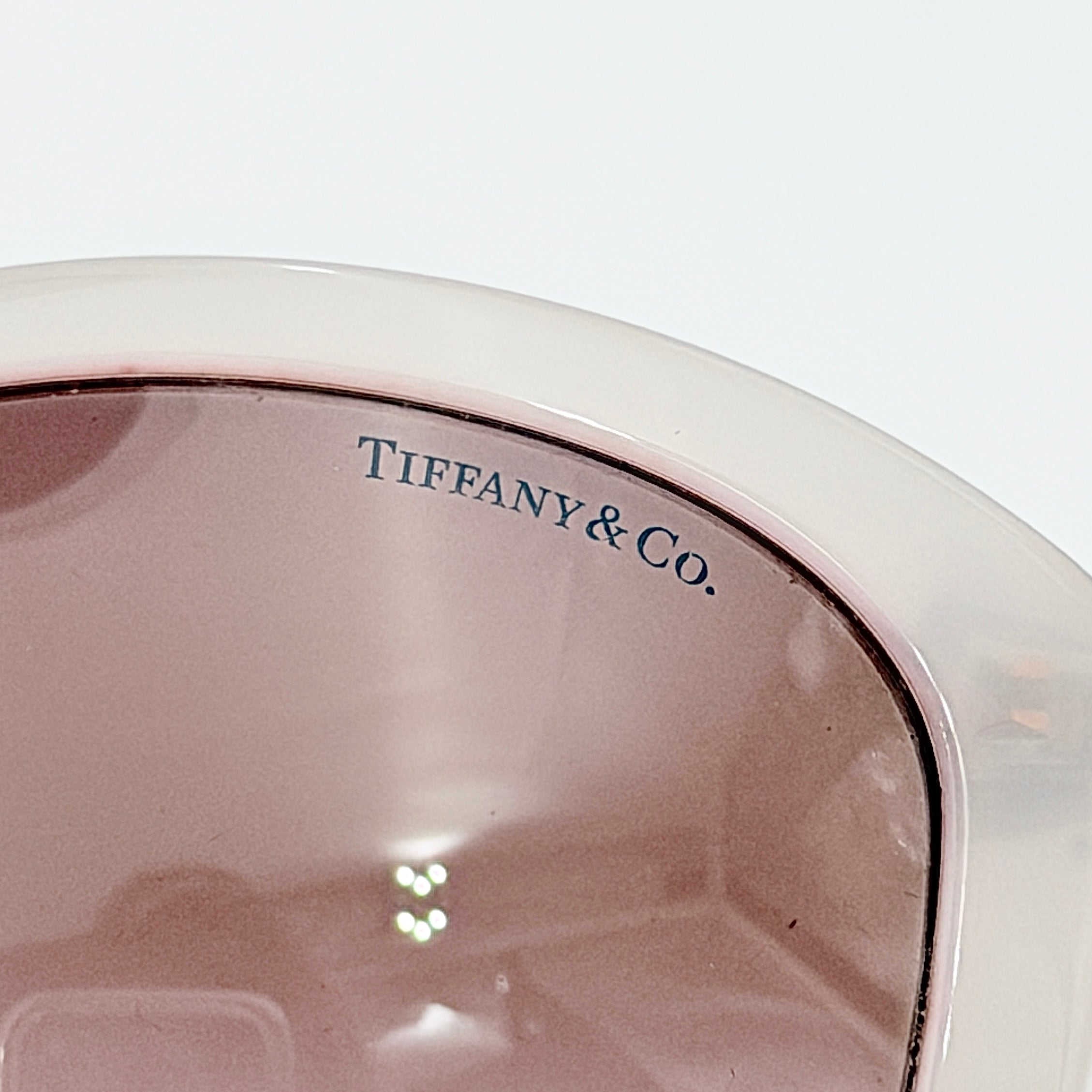 Tiffany & Co. TF4144 sunglasses in pink with gold-tone knot detail arms, shown with signature blue case.