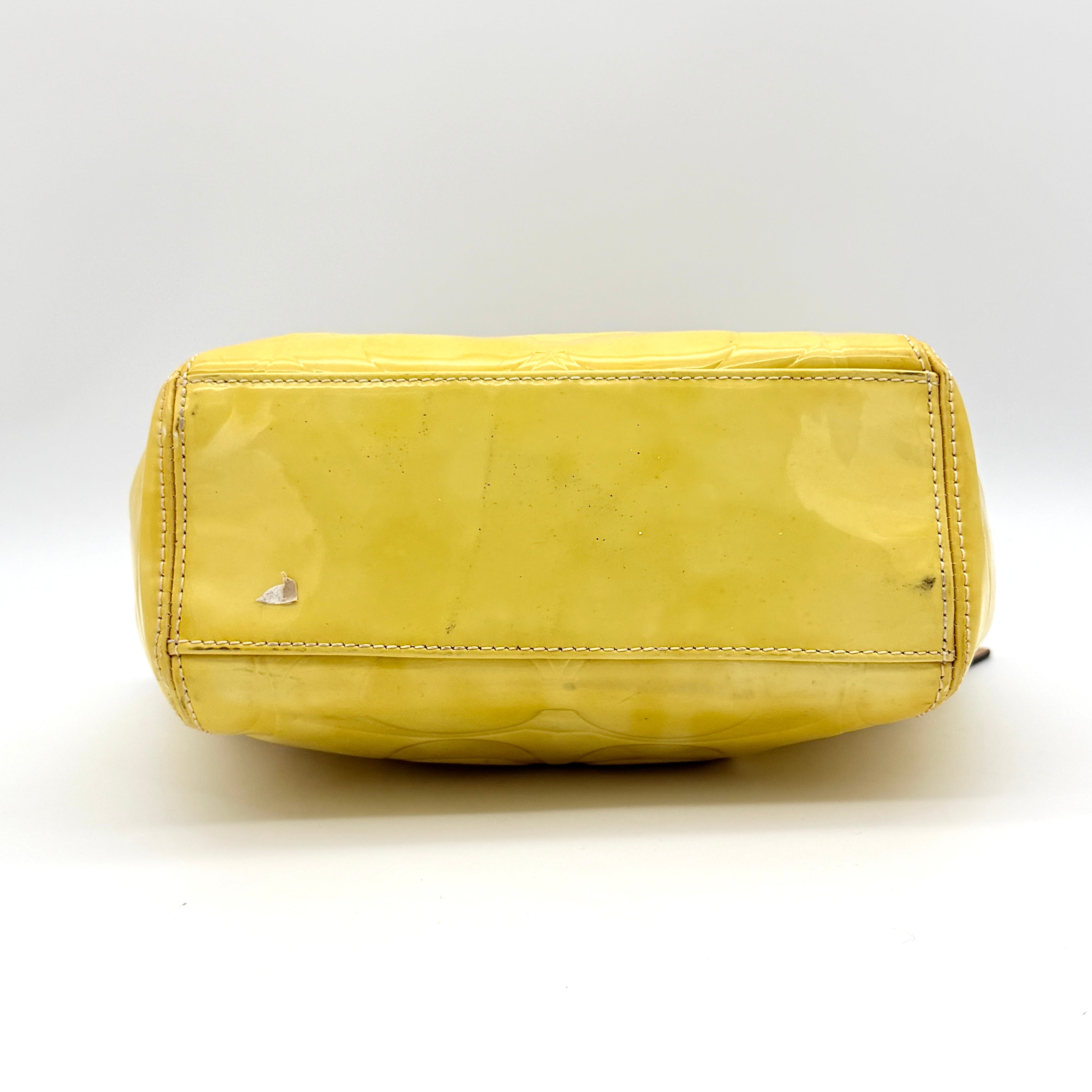 Coach Peyton tote in glossy yellow patent leather with tan handles and detachable strap, shown with blush pink interior.